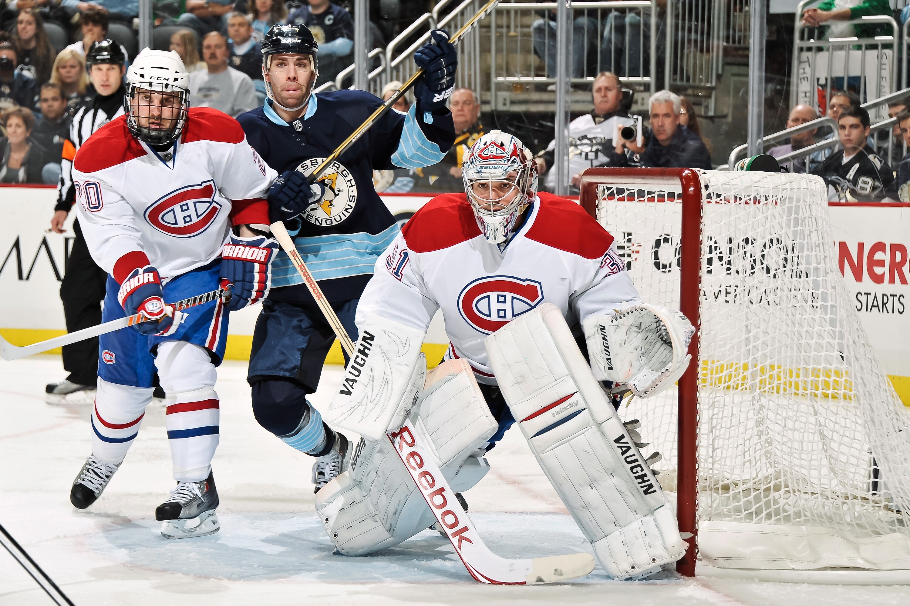 PITTSBURGH, PA - MARCH 12:  James Wisniewski #20 of the Montreal Canadiens and Pascal Dupuis #9 of the Pittsburgh Penguins battle for position near goaltender Carey Price #31 of the Montreal Canadiens on March 12, 2011 at CONSOL Energy Center in Pittsburg