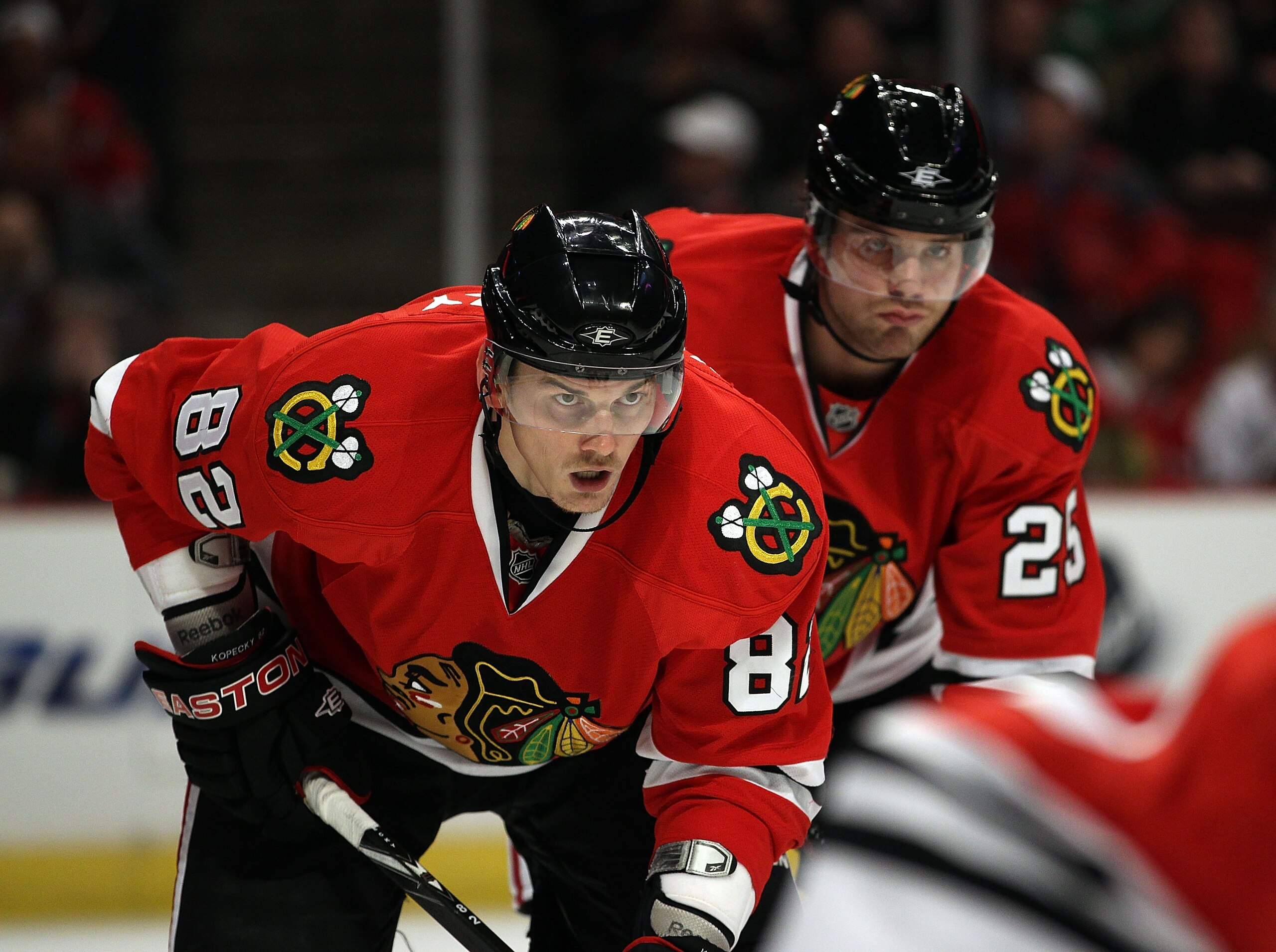 CHICAGO, IL - MARCH 02: Tomas Kopecky #82 and Viktor Stalberg #25 of the Chicago Blackhawks await a face-off against the Calgary Flames at the United Center on March 2, 2011 in Chicago, Illinois. The Blackhawks defeated the Flames 6-4. (Photo by Jonathan