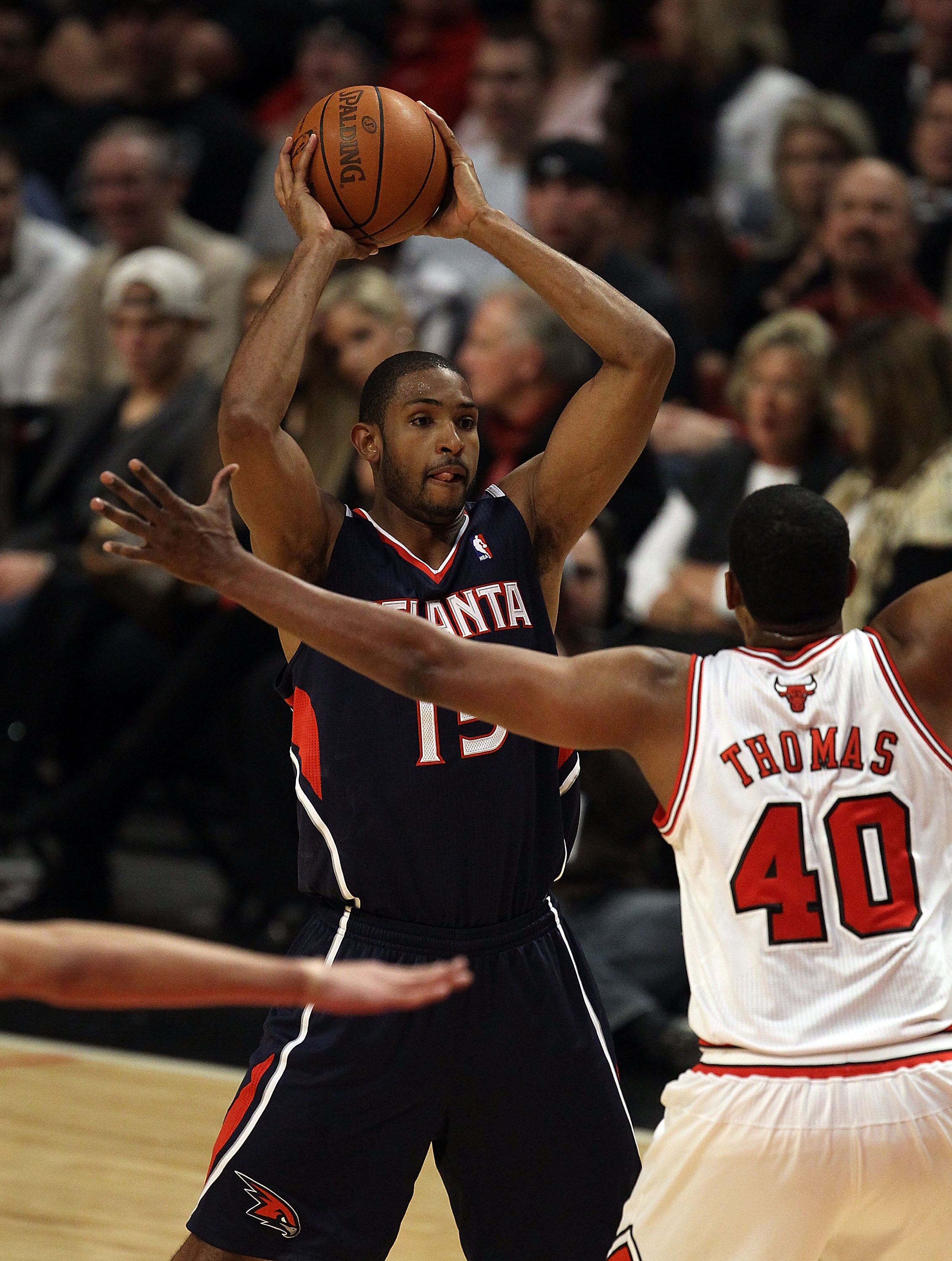 CHICAGO, IL - MARCH 11: Al Horford #15 of the Atlanta Hawks looks to pass against Kurt Thomas #40 of the Chicago Bulls at the United Center on March 11, 2011 in Chicago, Illinois. The Bulls defeated the Hawks 94-76. NOTE TO USER: User expressly acknowledg