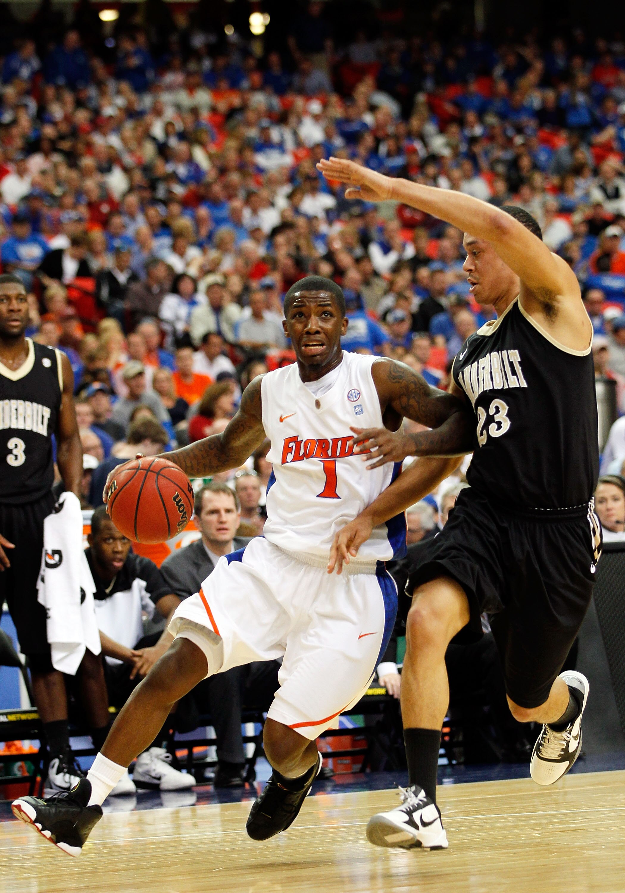 ATLANTA, GA - MARCH 12:  Kenny Boynton #1 of the Florida Gators drives against John Jenkins #23 of the Vanderbilt Commodores during the semifinals of the SEC Men's Basketball Tournament at Georgia Dome on March 12, 2011 in Atlanta, Georgia.  (Photo by Kev