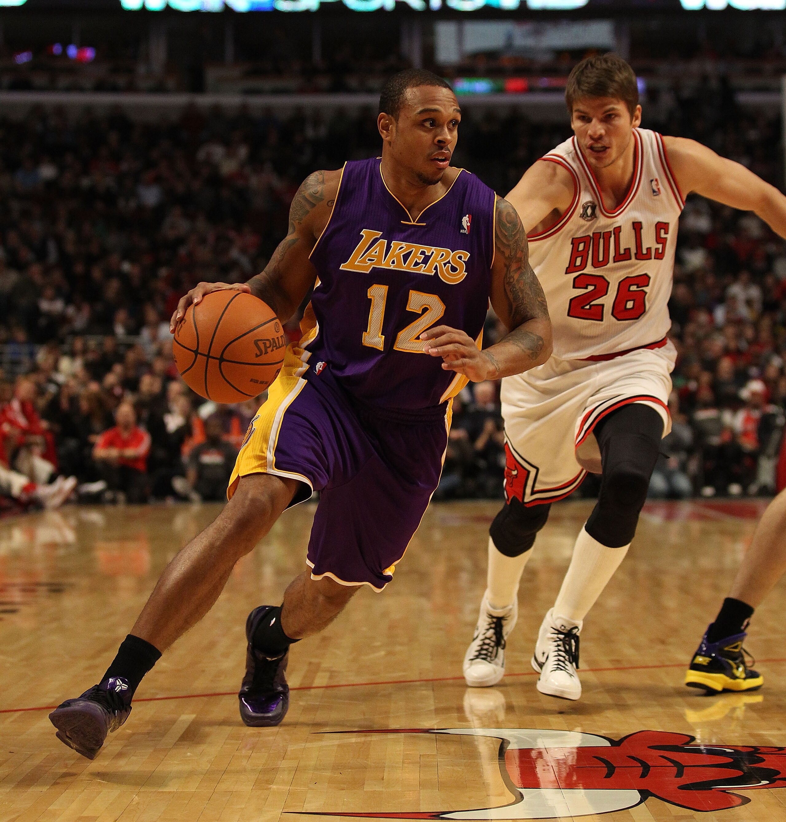 CHICAGO, IL - DECEMBER 10: Shannon Brown #12 of the Los Angeles Lakers drives around Kyle Korver #26 of the Chicago Bulls at the United Center on December 10, 2010 in Chicago, Illinois. The Bulls defeated the Lakers 88-84. NOTE TO USER: User expressly ack