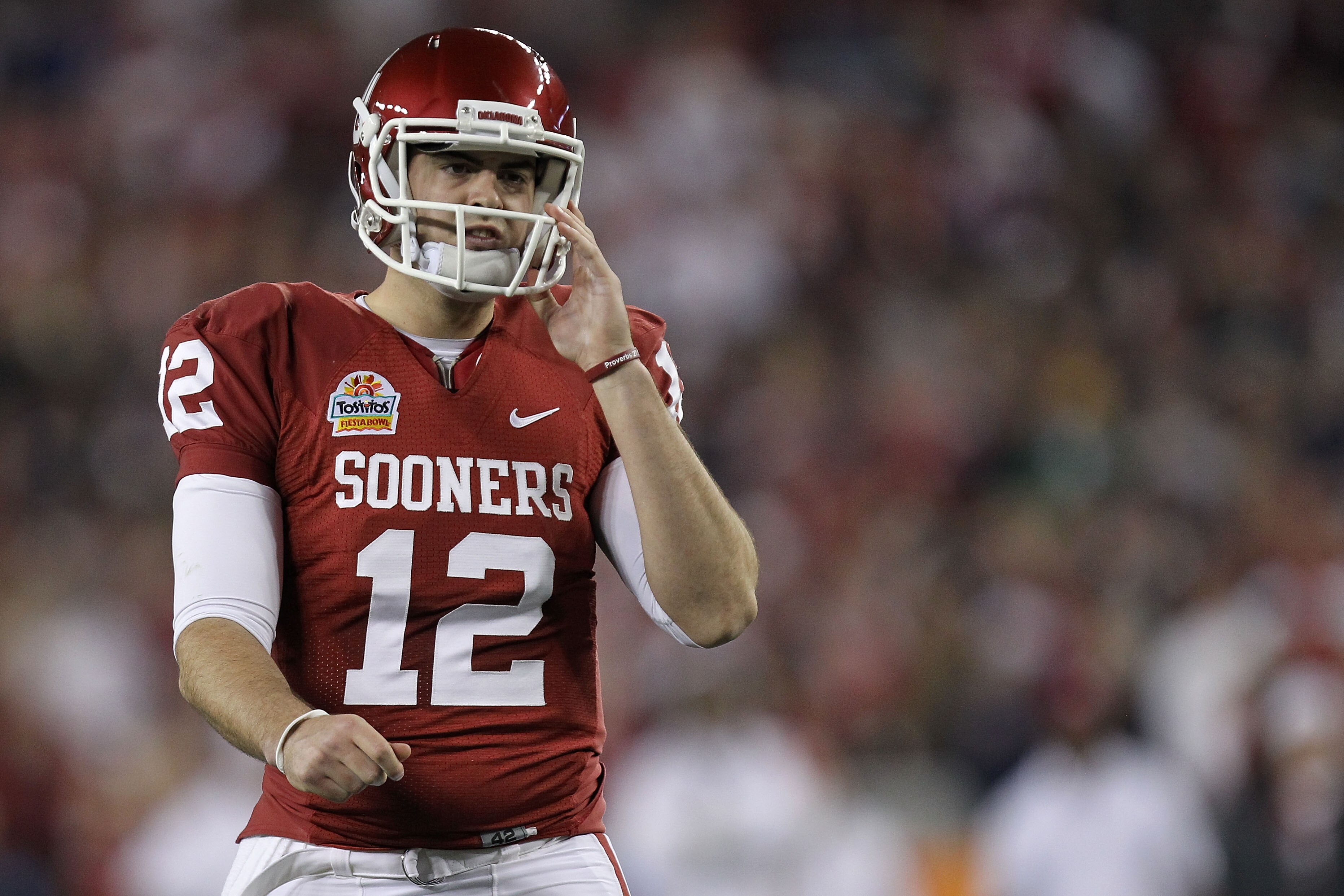 GLENDALE, AZ - JANUARY 01:  Landry Jones #12 of the Oklahoma Sooners looks on in the first half against the Connecticut Huskies during the Tostitos Fiesta Bowl at the Universtity of Phoenix Stadium on January 1, 2011 in Glendale, Arizona.  (Photo by Ronal
