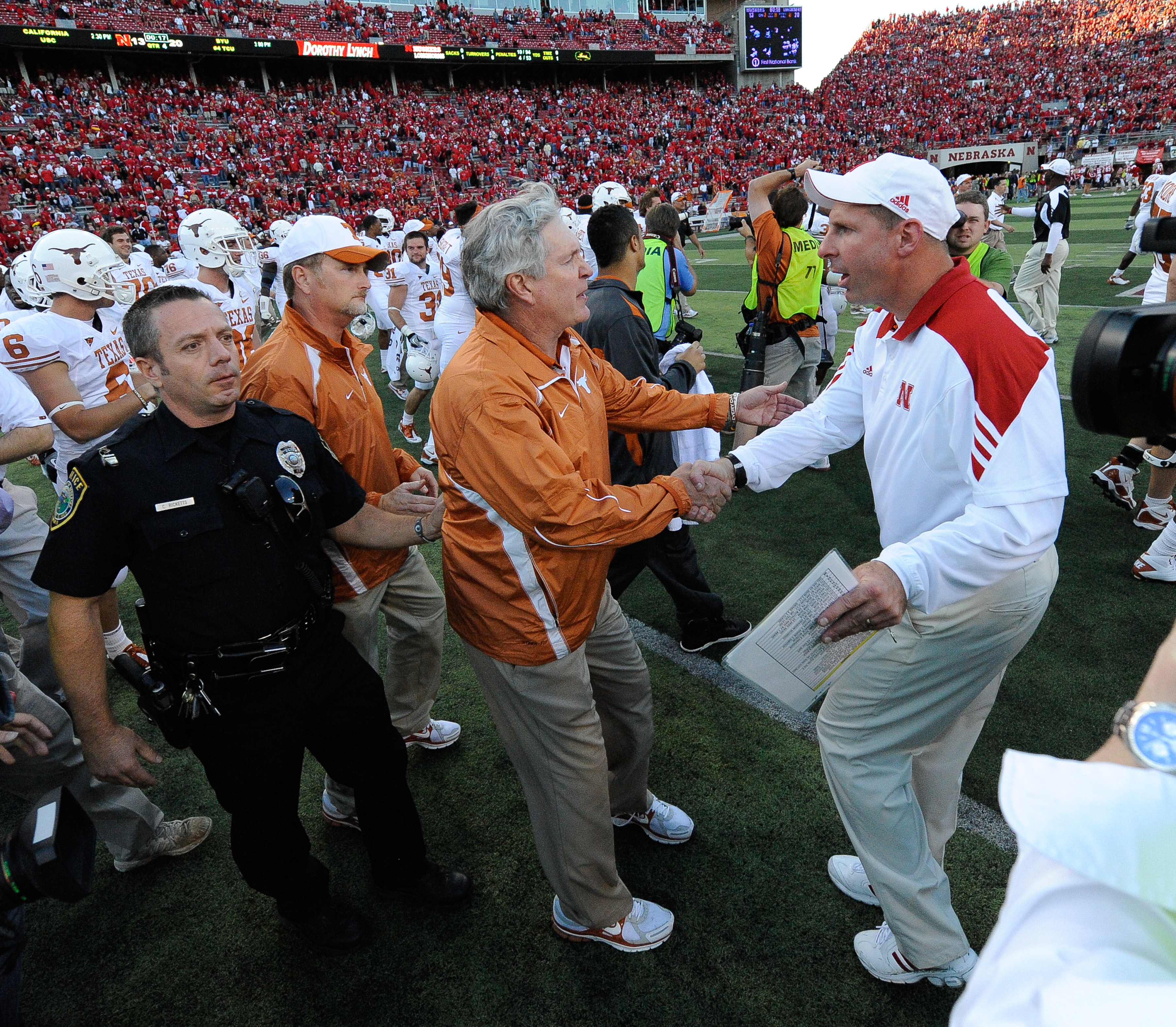 LINCOLN, NE - OCTOBER 16: Coach Mack Brown (left) of the Texas Longhorns shakes hands with Coach Bo Pelini of the Nebraska Cornhuskers after their game at Memorial Stadium on October 16, 2010 in Lincoln, Nebraska. Texas Defeated Nebraska 20-13. (Photo by