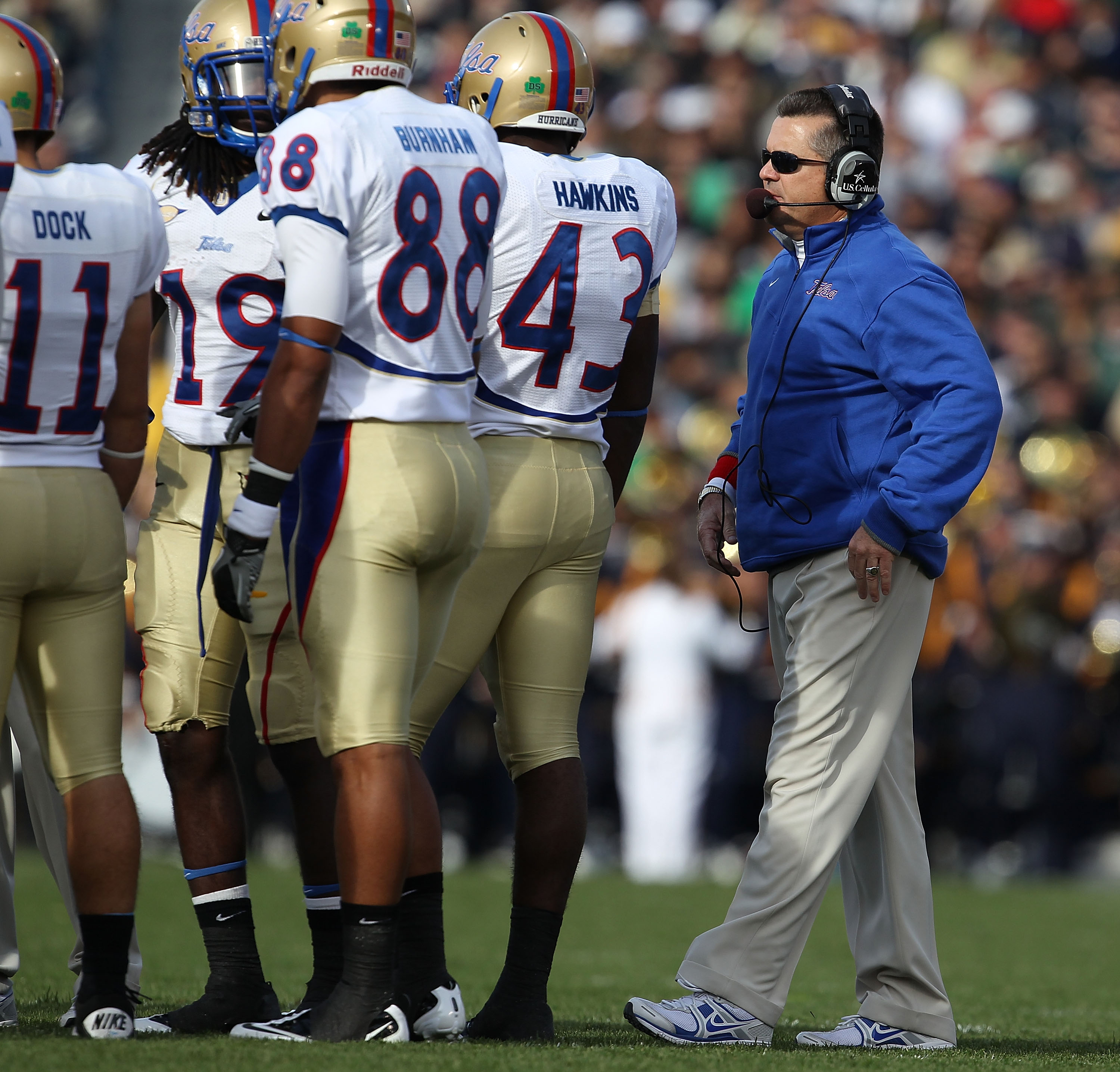 SOUTH BEND, IN - OCTOBER 30: Head coach Todd Graham of the Tulsa Golden Hurricane talks to his team including (L-R) Alan Dock #11, Milton Howell #19, Bryan Burnham #88 and Donnell Hawkins #43 during a game against the Notre Dame Fighting Irish at Notre Da