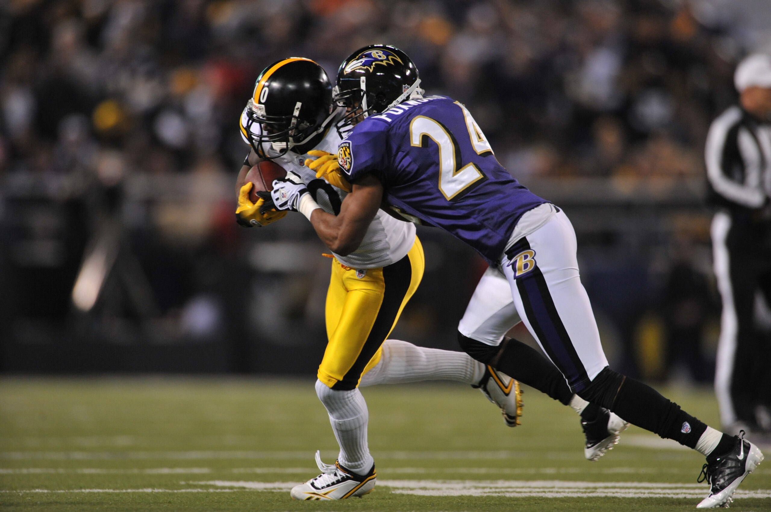 BALTIMORE - NOVEMBER 29:  Domonique Foxworth #24 of the Baltimore Ravens makes a tackle against the Pittsburgh Steelers at M&T Bank Stadium on November 29, 2009 in Baltimore, Maryland. The Ravens defeated the Steelers 20-17. (Photo by Larry French/Getty I
