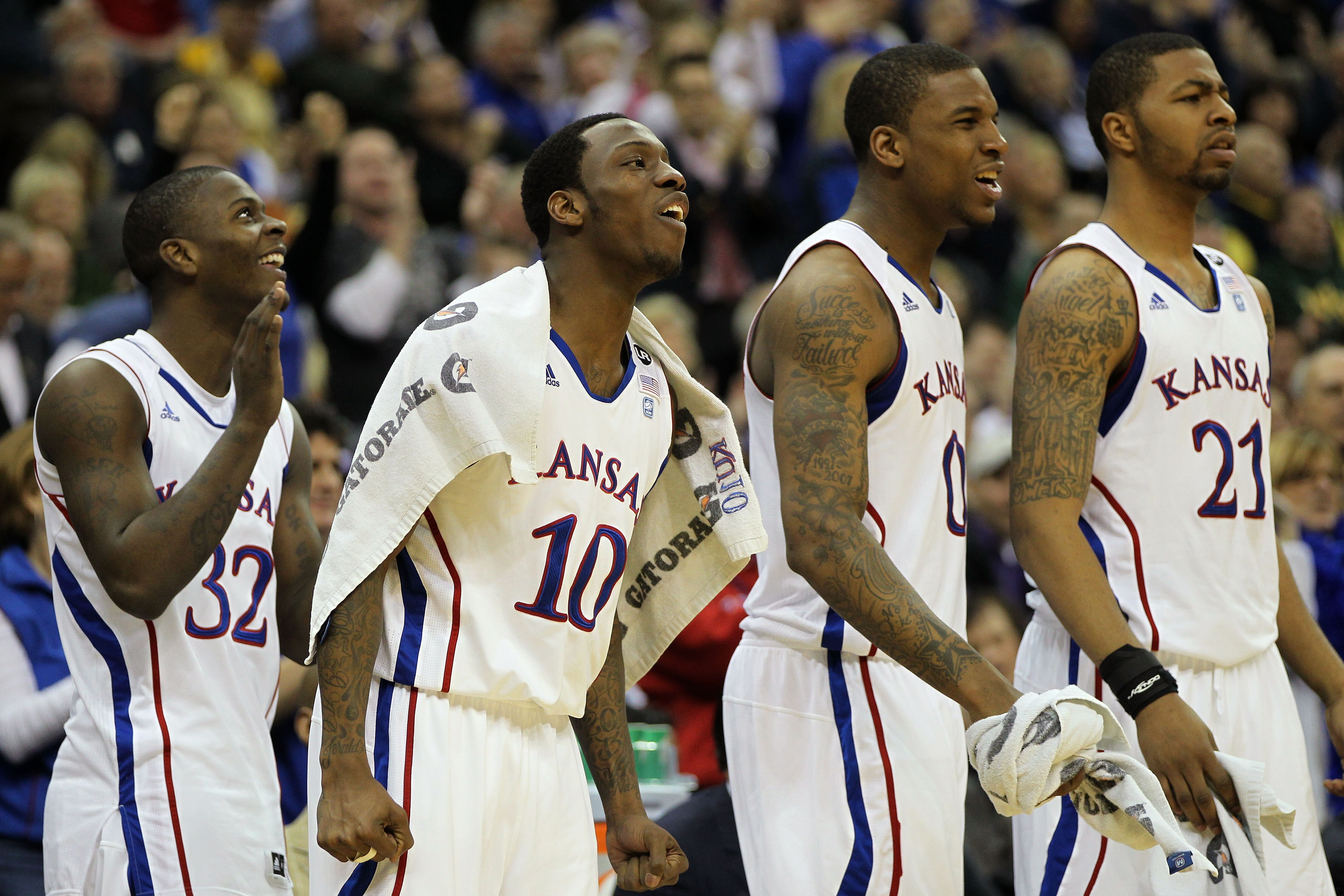 KANSAS CITY, MO - MARCH 10: Josh Selby #32, Tyshawn Taylor #10, Thomas Robinson #0, and Markieff Morris #21 of the Kansas Jayhawks cheer from the bench during their quarterfinal game against the Oklahoma State Cowboys in the 2011 Phillips 66 Big 12 Men's KANSAS CITY, MO - MARCH 10: Josh Selby #32, Tyshawn Taylor #10, Thomas Robinson #0, and Markieff Morris #21 of the Kansas Jayhawks cheer from the bench during their quarterfinal game against the Oklahoma State Cowboys in the 2011 Phillips 66 Big 12 Men's