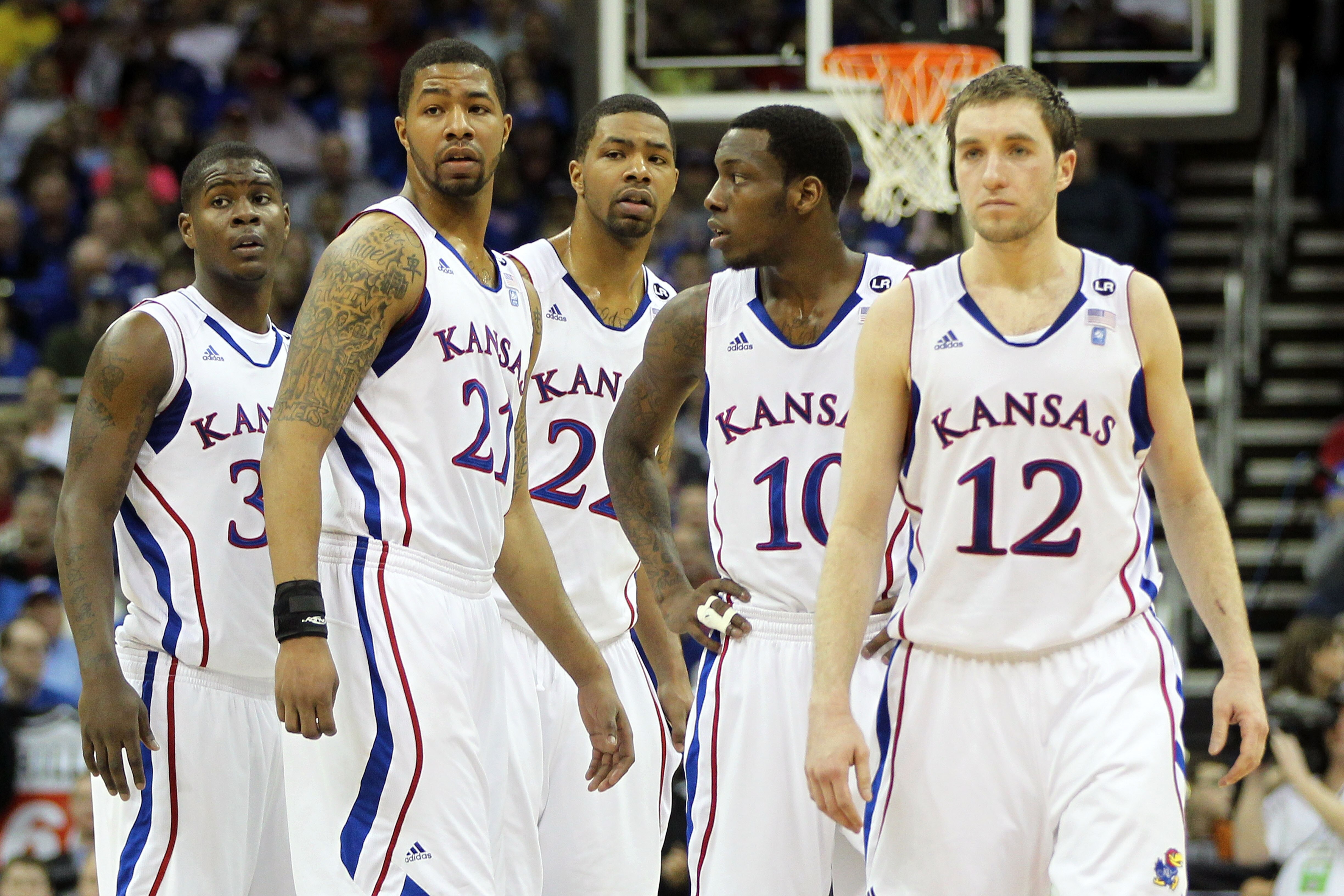 KANSAS CITY, MO - MARCH 12: Josh Selby #32, Markieff Morris #21, Marcus Morris #22,Tyshawn Taylor #10 and Brady Morningstar #12 of the Kansas Jayhawks stand on the court against the Texas Longhorns during the 2011 Phillips 66 Big 12 Men's Basketball Tour KANSAS CITY, MO - MARCH 12: Josh Selby #32, Markieff Morris #21, Marcus Morris #22,Tyshawn Taylor #10 and Brady Morningstar #12 of the Kansas Jayhawks stand on the court against the Texas Longhorns during the 2011 Phillips 66 Big 12 Men's Basketball Tour