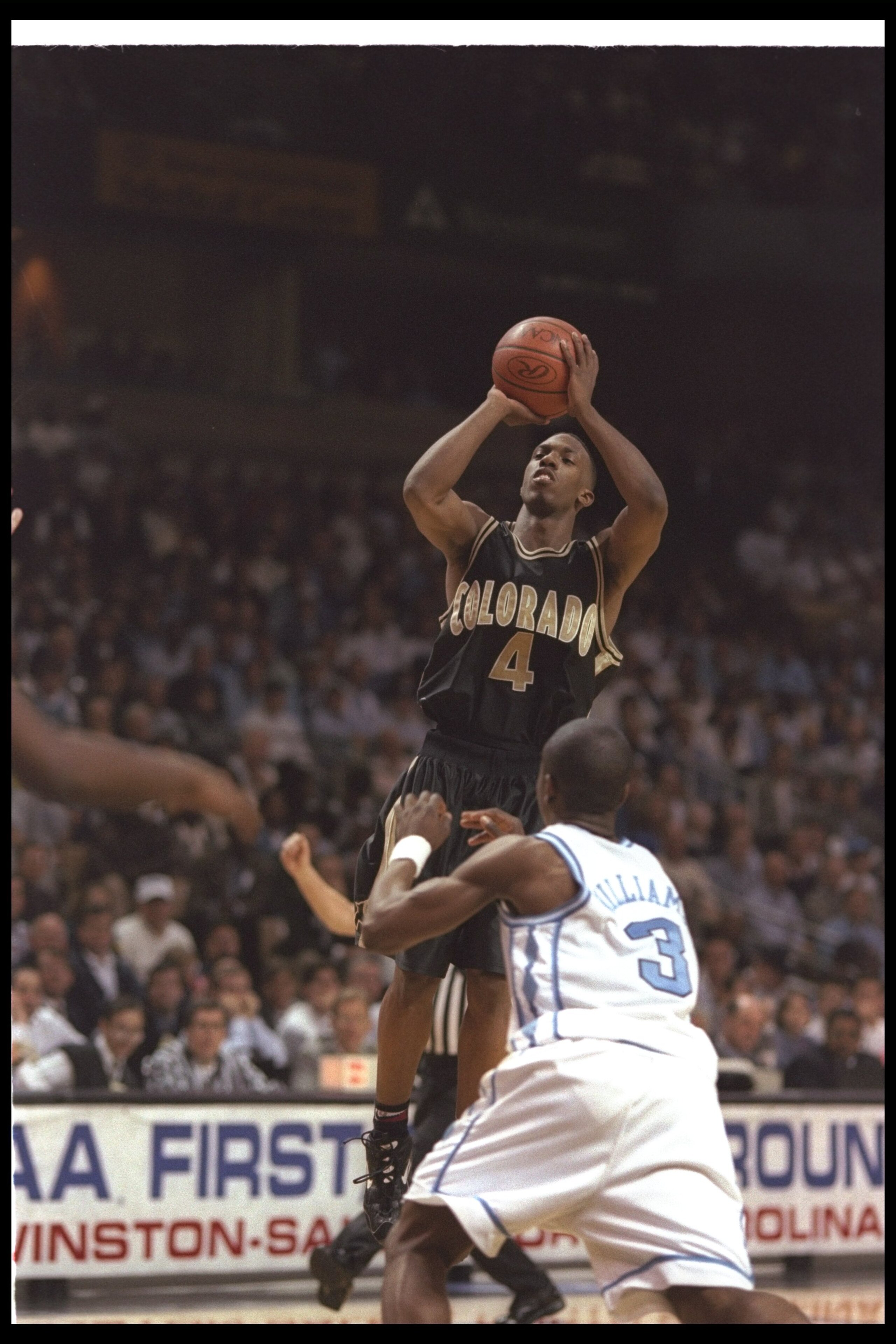 15 Mar 1997:  Guard Chauncey Billups of the Colorado Buffaloes shoots the ball as guard Shammond Williams of the North Carolina Tarheels tries to guard him during a playoff game at the Lawrence Joel Veteran Memorial Coliseum in Winston-Salem, North Caroli