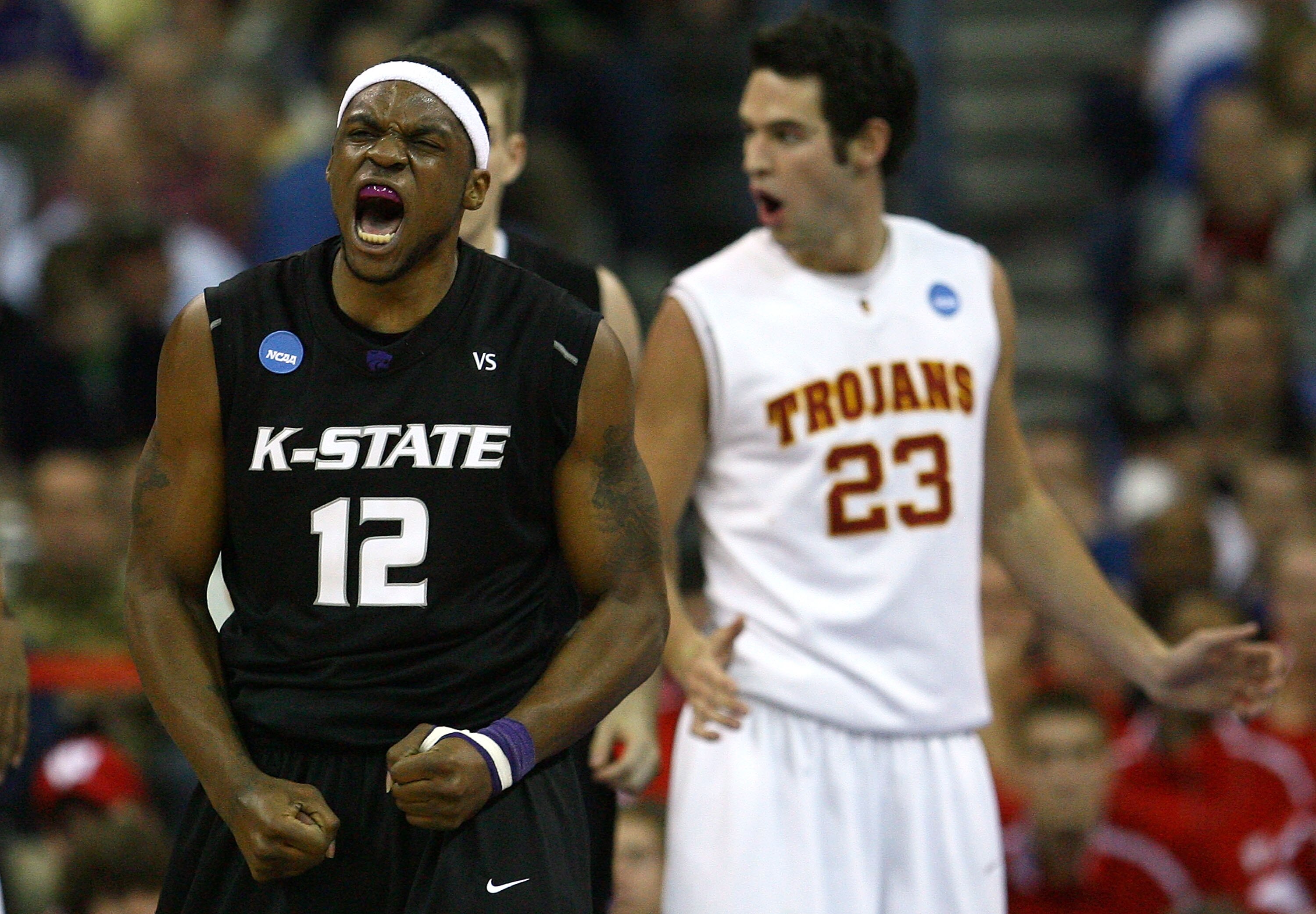 OMAHA, NE - MARCH 20:  Bill Walker #12 of the Kansas State Wildcats celebrates a play as Keith Wilkinson #23 of the USC Trojans looks on in disbelief during the Midwest Region first round of the 2008 NCAA Men's Basketball Tournament on March 20, 2008 at t