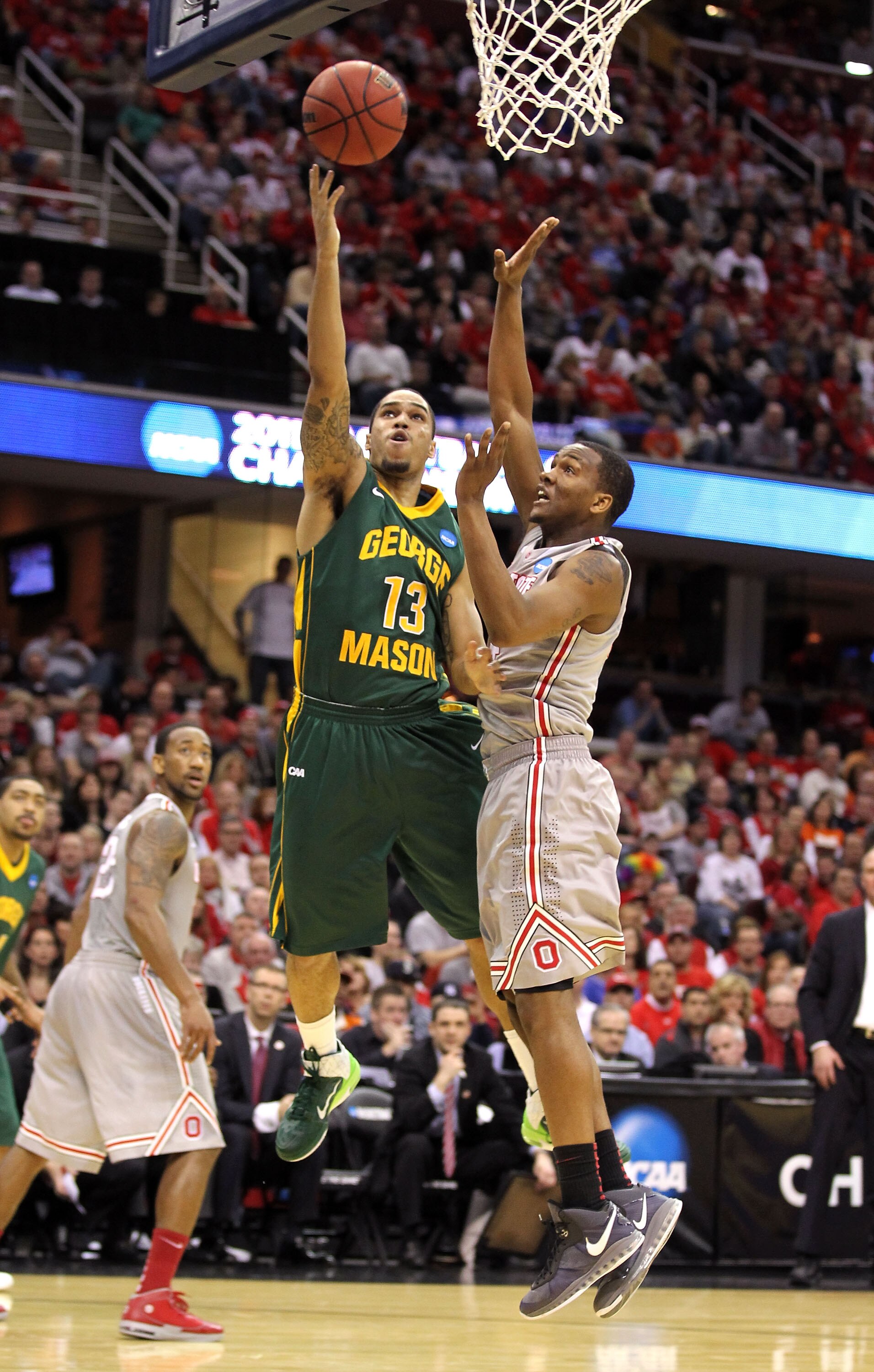 CLEVELAND, OH - MARCH 20: Isaiah Tate #13 of the George Mason Patriots drives to the basket against William Buford #44 of the Ohio State Buckeyes during the third of the 2011 NCAA men's basketball tournament at Quicken Loans Arena on March 20, 2011 in Cle