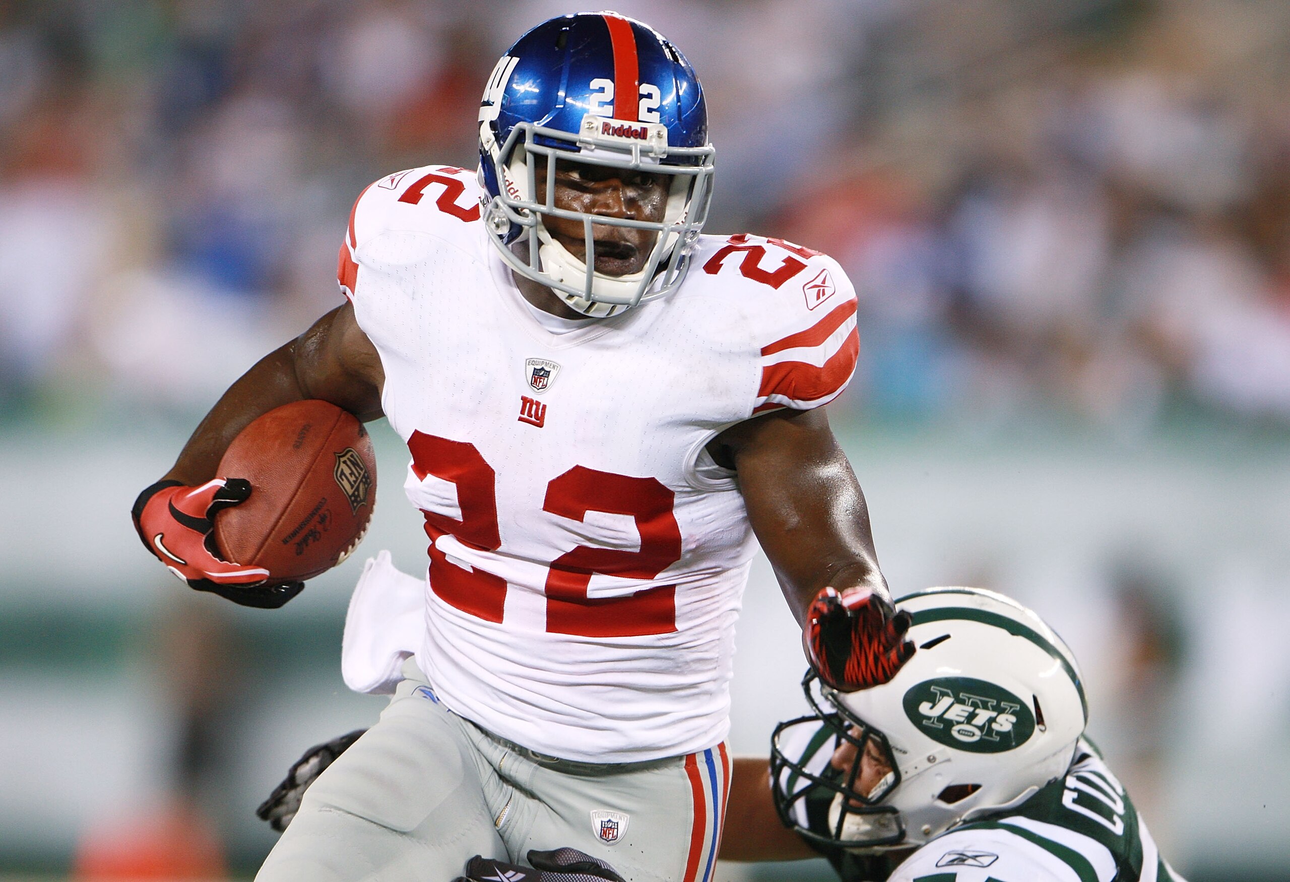 EAST RUTHERFORD, NJ - AUGUST 16:  Andre Brown #22 of the New York Giants breaks a tackle against the New York Jets during the preseason game at New Meadowlands Stadium on August 16, 2010 in East Rutherford, New Jersey. The  Giants won 31 - 16. (Photo by A