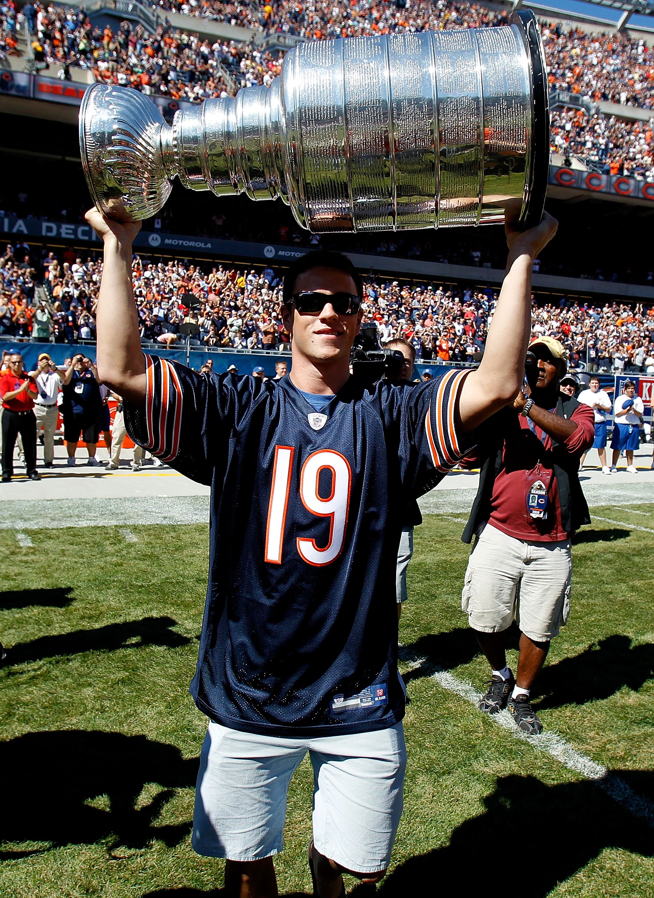 CHICAGO - SEPTEMBER 12: Jonathan Toews of the Chicago Blackhawks carries the Stanley Cup to the field before the NFL opening season game between  the Chicago Bears and the Detroit Lions at Soldier Field on September 12, 2010 in Chicago, Illinois.  The Bea