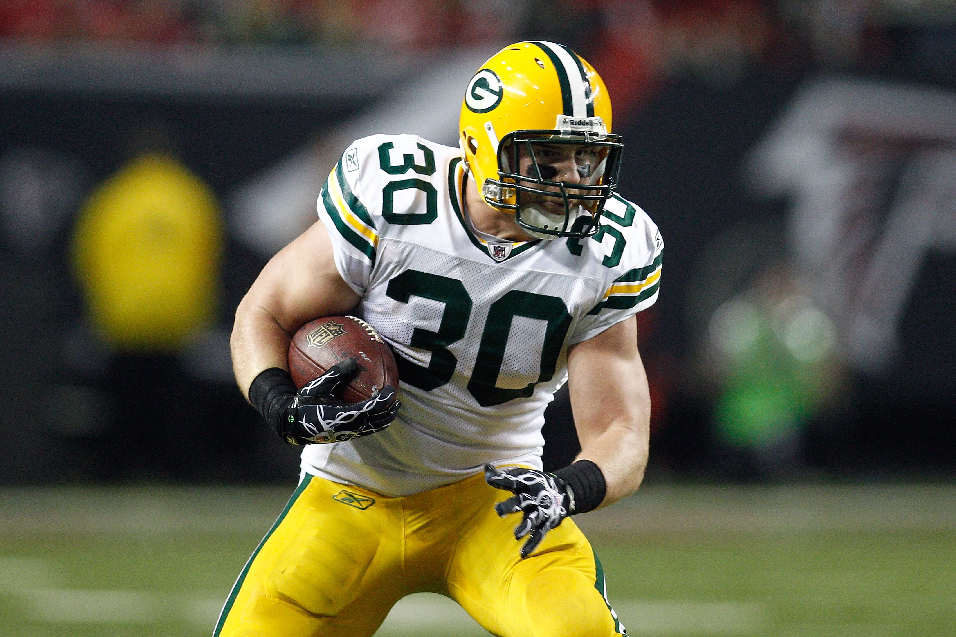 ATLANTA, GA - JANUARY 15: John Kuhn #30 of the Green Bay Packers runs the ball against the Atlanta Falcons during their 2011 NFC divisional playoff game at Georgia Dome on January 15, 2011 in Atlanta, Georgia. The Packers won 48-21. (Photo by Chris Gray ATLANTA, GA - JANUARY 15: John Kuhn #30 of the Green Bay Packers runs the ball against the Atlanta Falcons during their 2011 NFC divisional playoff game at Georgia Dome on January 15, 2011 in Atlanta, Georgia. The Packers won 48-21. (Photo by Chris Gray