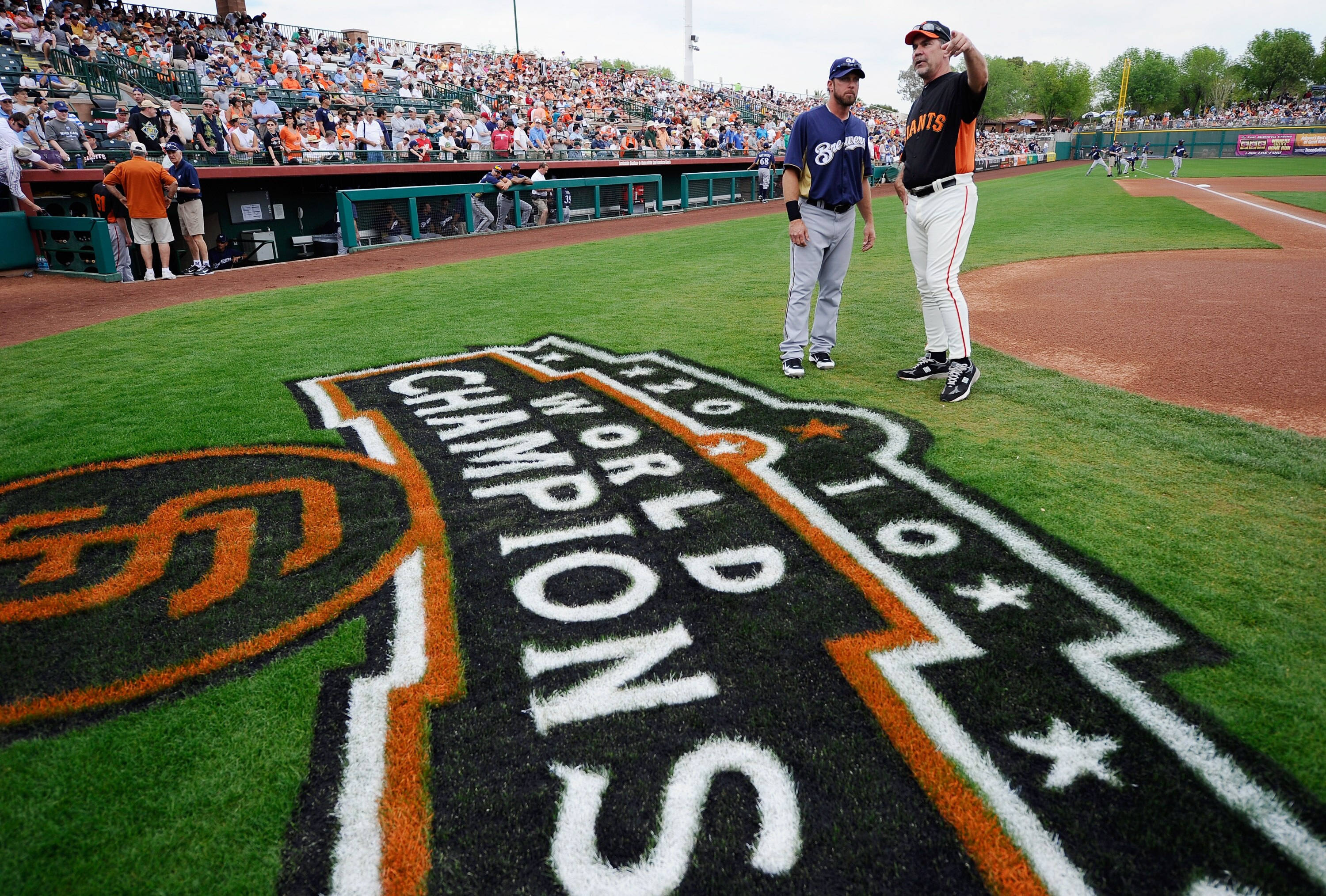 SCOTTSDALE, AZ - MARCH 14:  Manager Bruce Botchy #15 of the San Francisco Giants talks with Mark Kotsay #25 of the Milwaukee Brewers during the spring training baseball game against tat Scottsdale Stadium on March 14, 2011 in Scottsdale, Arizona.  (Photo