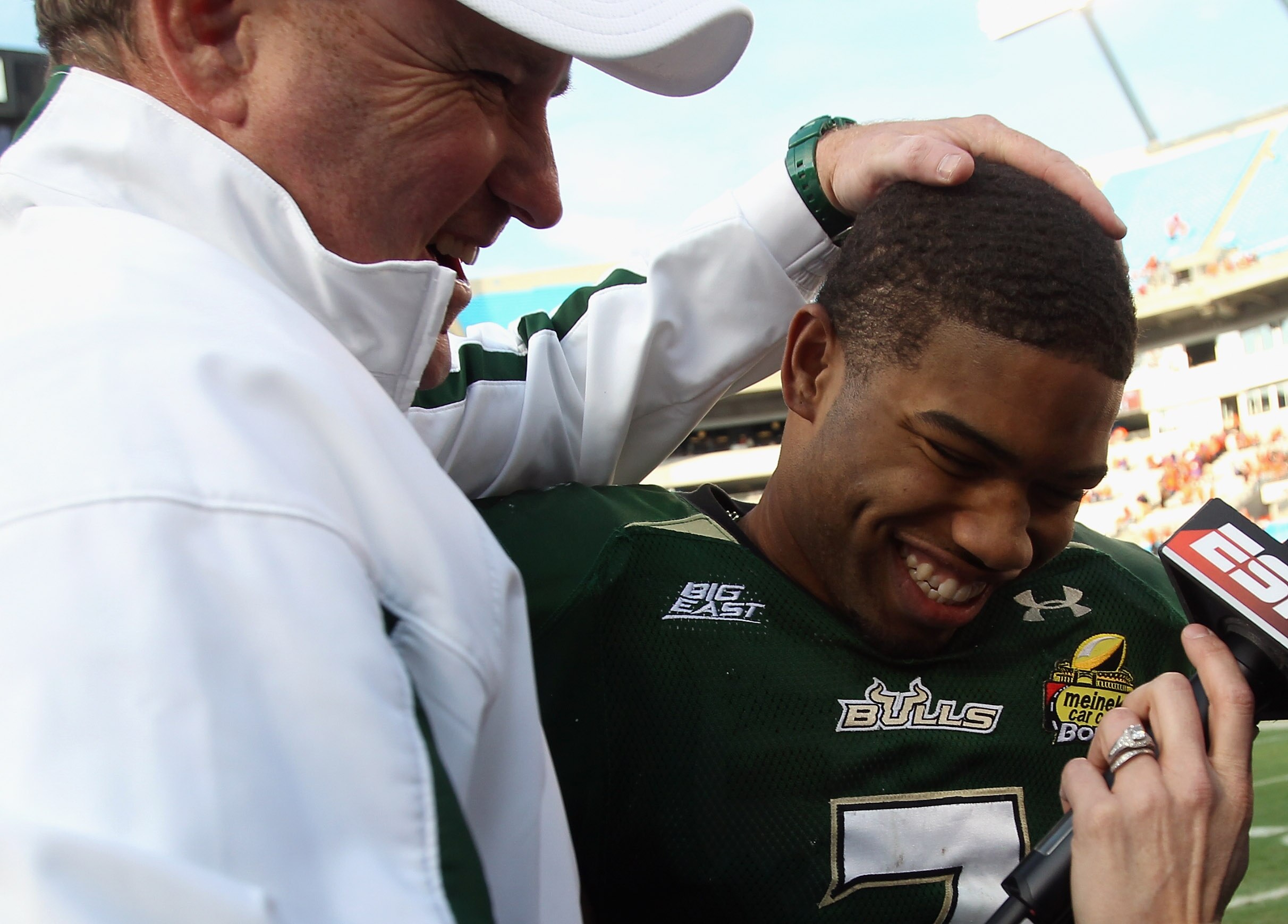 CHARLOTTE, NC - DECEMBER 31:  Head coach Skip Holtz stands with MVP B.J. Daniels #7 of the USF Bulls after a 31-26 victory over the Clemson Tigers at Bank of America Stadium on December 31, 2010 in Charlotte, North Carolina.  (Photo by Streeter Lecka/Gett