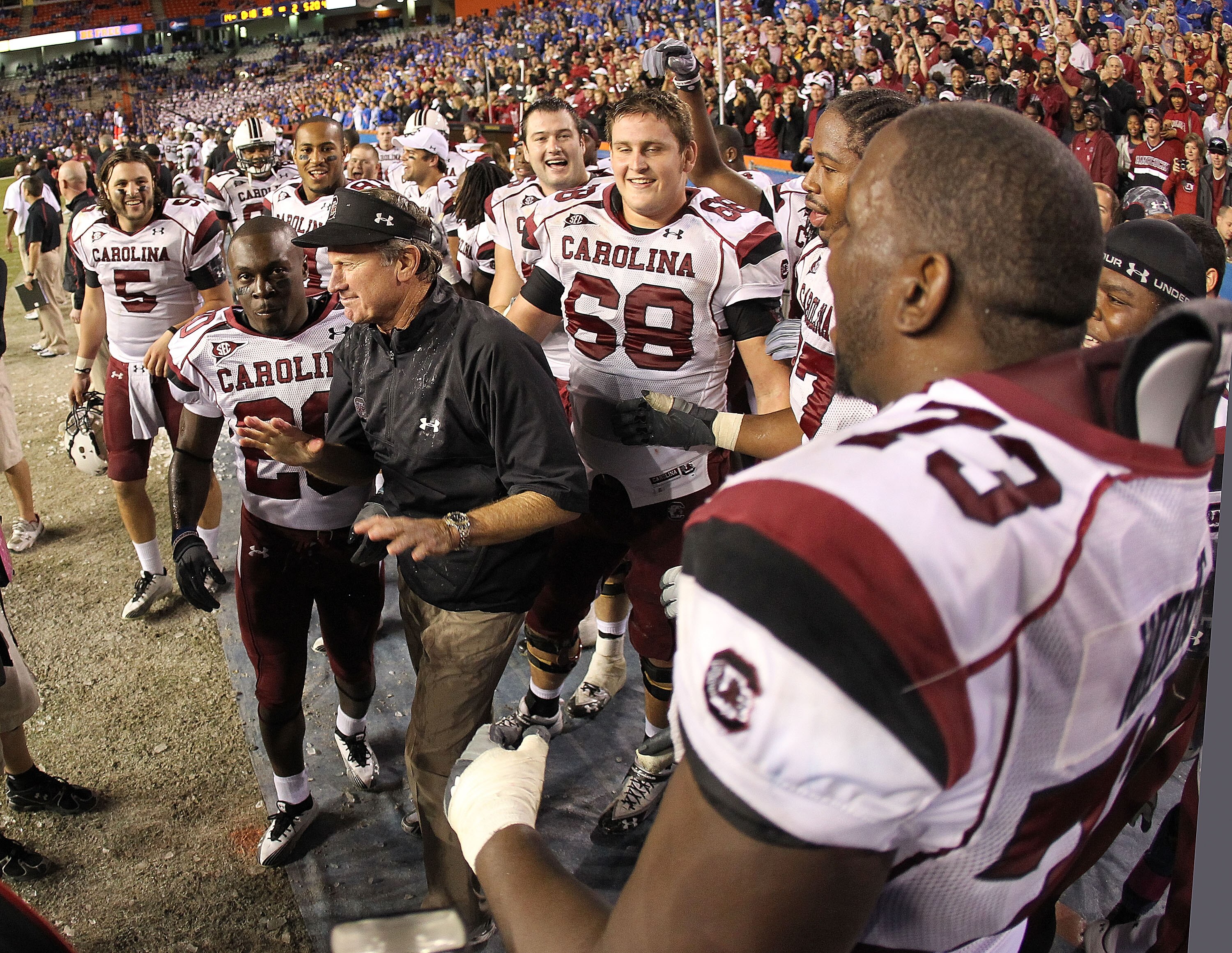 GAINESVILLE, FL - NOVEMBER 13:  South Carolina Gamecocks head coach Steve Spurrier greets his players after winning a game against the Florida Gators at Ben Hill Griffin Stadium on November 13, 2010 in Gainesville, Florida. The Gamecocks beat the Gators 3