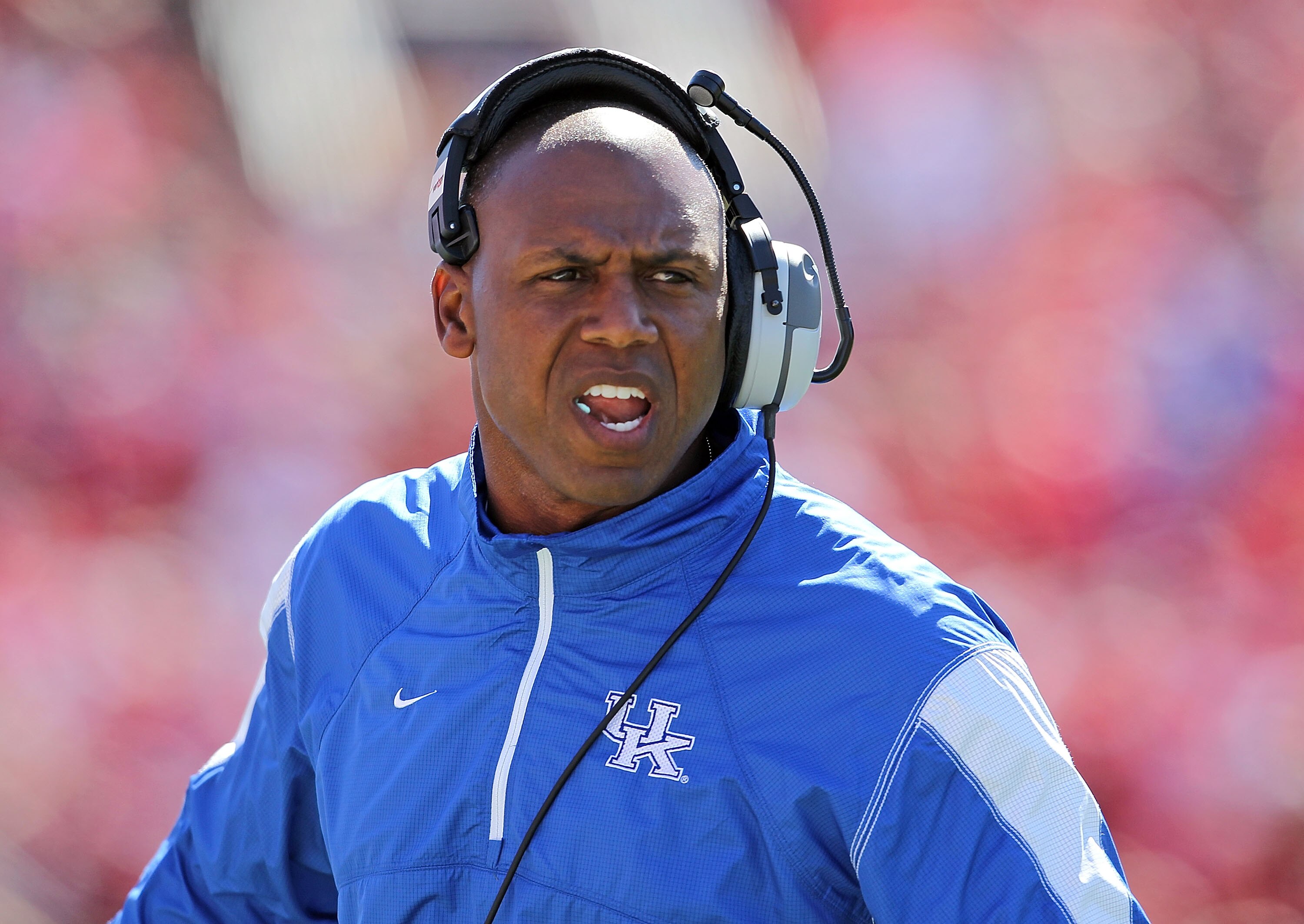 LOUISVILLE, KY - SEPTEMBER 04: Joker Phillips the Head Coach of the Kentucky Wildcats gives instructions to his team during the game against the Louisville Cardinals at Papa John's Cardinal Stadium on September 4, 2010 in Louisville, Kentucky.  (Photo by 