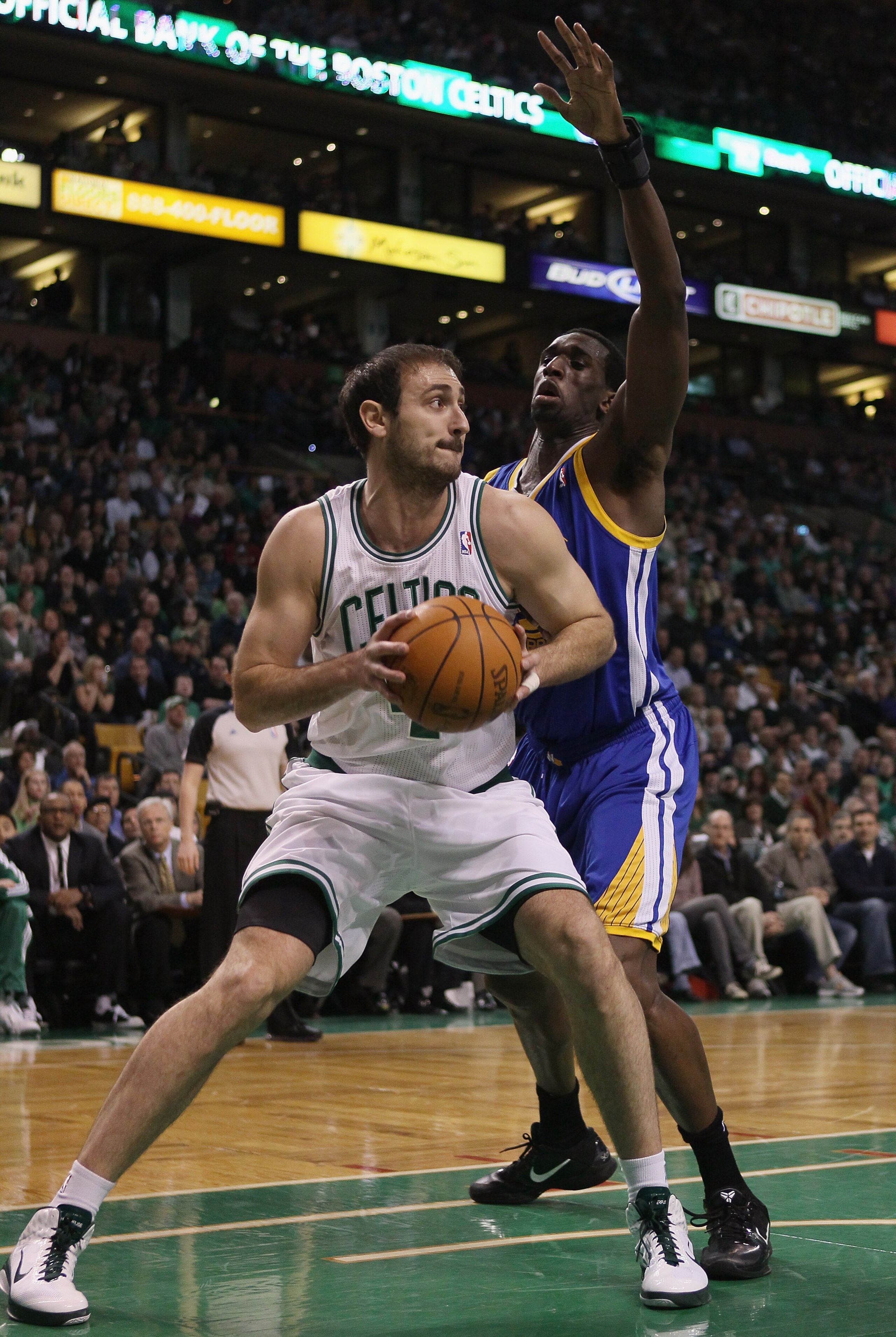 BOSTON, MA - MARCH 04:  Nenad Krstic #4 of the Boston Celtics heads for the net as Ekpe Udoh #20 of the Golden State Warriors defends on March 4, 2011 at the TD Garden in Boston, Massachusetts.  NOTE TO USER: User expressly acknowledges and agrees that, b