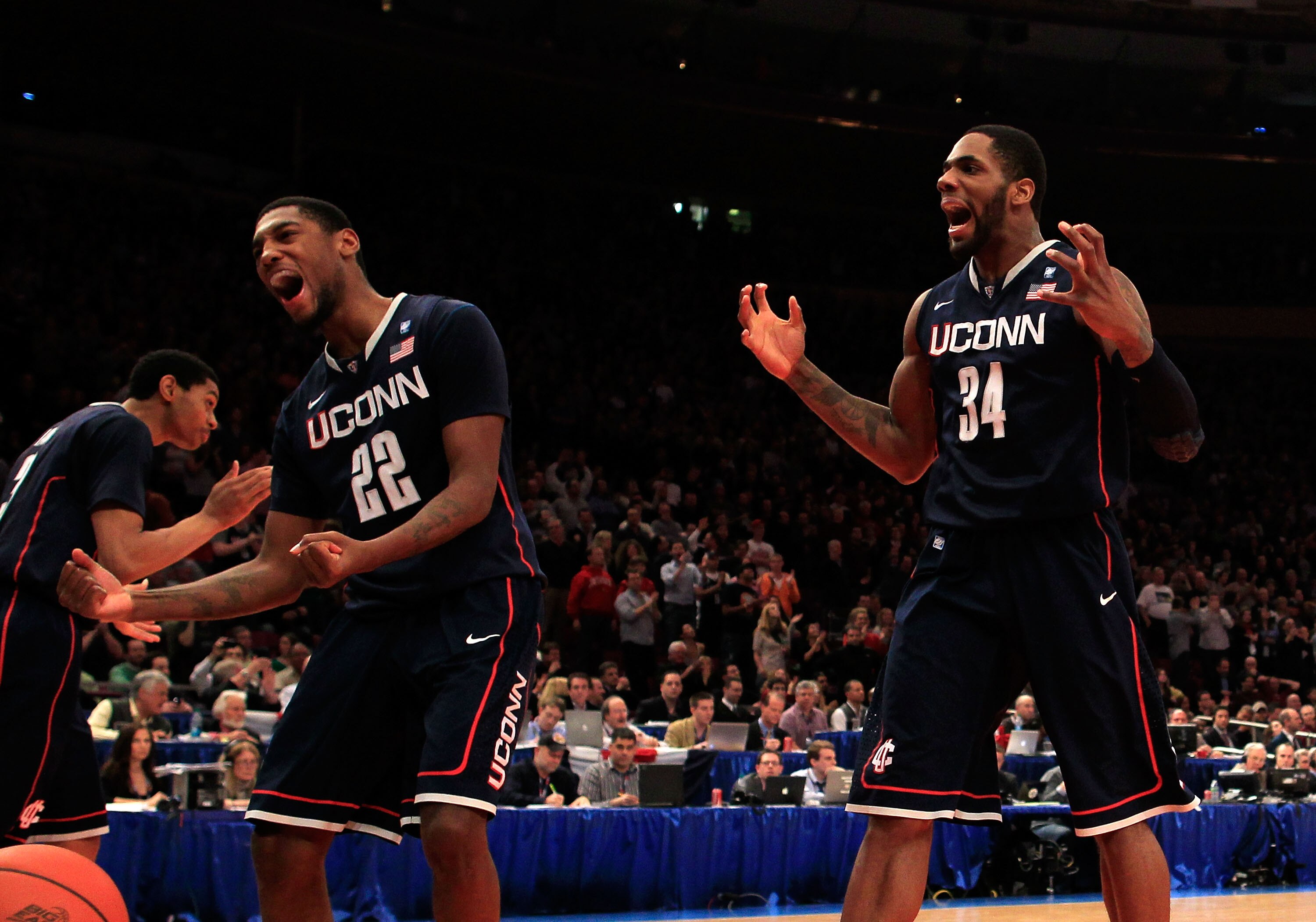 NEW YORK, NY - MARCH 12: Roscoe Smith #22 and Alex Oriakhi #34 of the Connecticut Huskies celebrate after teammate Kemba Walker made a late free throw against the Louisville Cardinals during the championship of the 2011 Big East Men's Basketball Tournamen