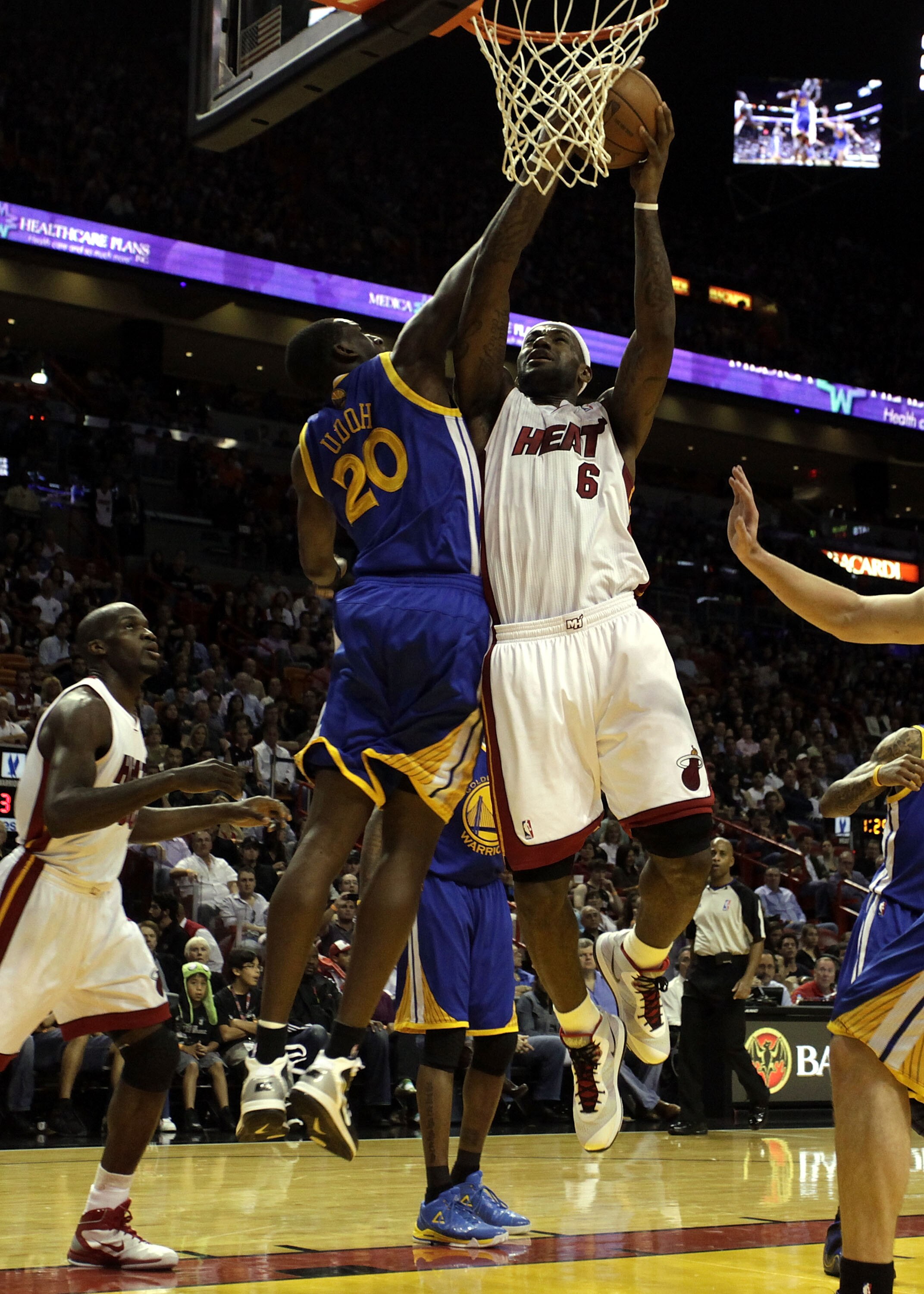 MIAMI, FL - JANUARY 01:  Forward LeBron James #6 of the Miami Heat scores againts forward Ekpe Udoh #20 of the Golden State Warriors at American Airlines Arena on January 1, 2011 in Miami, Florida.  NOTE TO USER: User expressly acknowledges and agrees tha