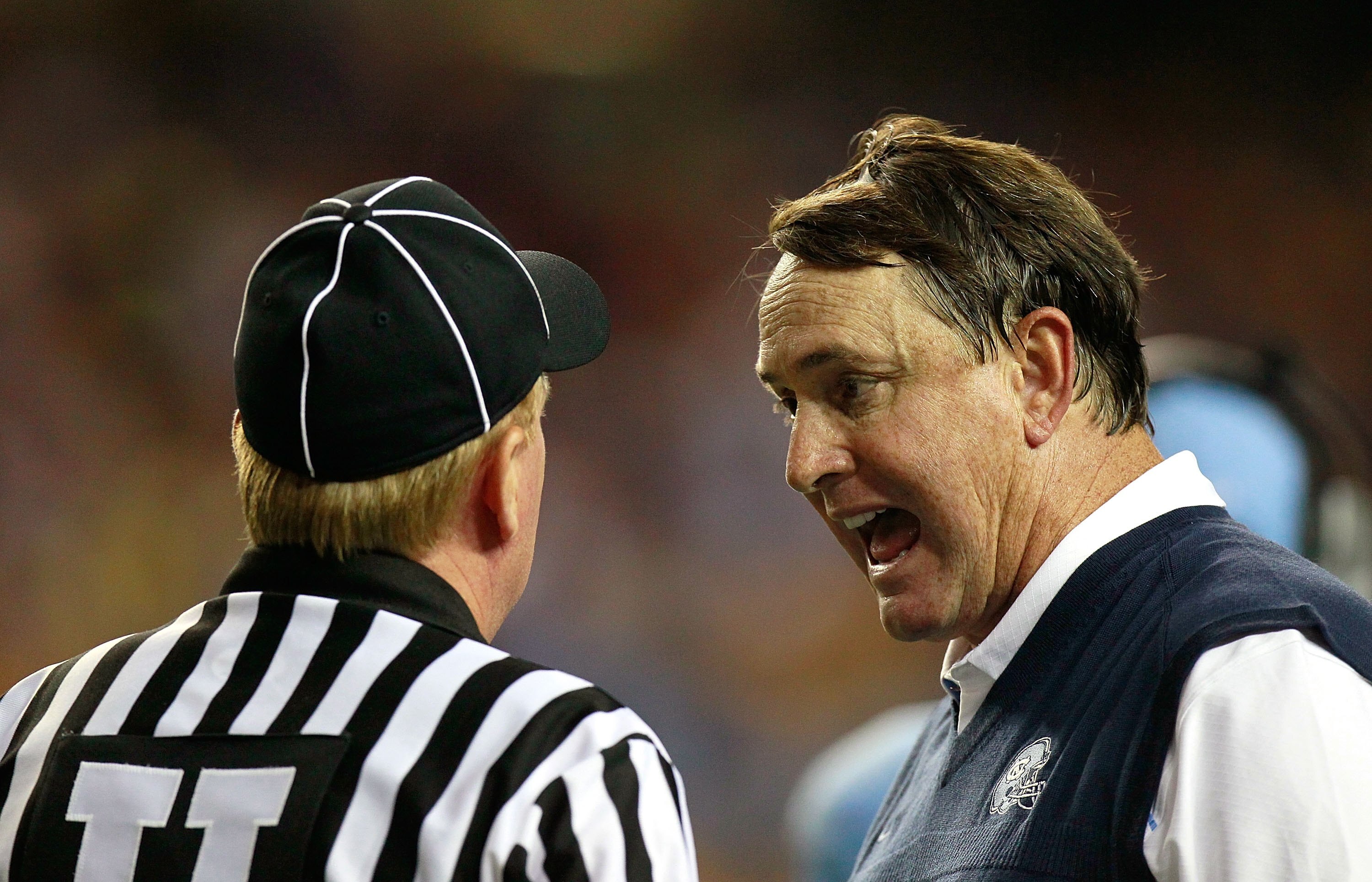 ATLANTA - SEPTEMBER 04: Head coach Butch Davis of the North Carolina Tar Heels and Umpire Brent Sowell during the game against the LSU Tigers in the Chick-fil-A Kickoff Game at Georgia Dome on September 4, 2010 in Atlanta, Georgia. (Photo by Kevin C. Co ATLANTA - SEPTEMBER 04: Head coach Butch Davis of the North Carolina Tar Heels and Umpire Brent Sowell during the game against the LSU Tigers in the Chick-fil-A Kickoff Game at Georgia Dome on September 4, 2010 in Atlanta, Georgia. (Photo by Kevin C. Co