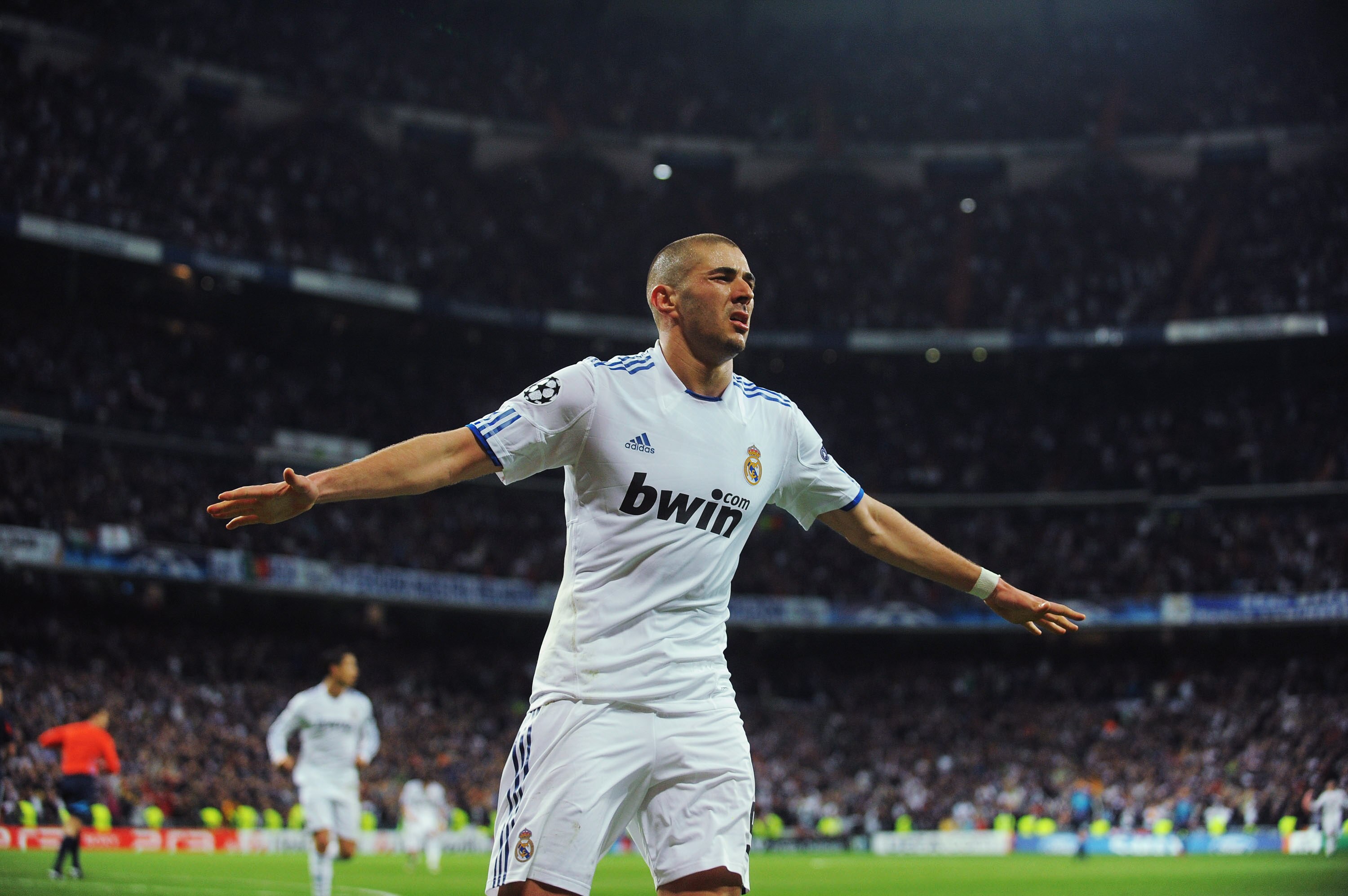 MADRID, SPAIN - MARCH 16:  Karim Benzema of Real Madrid celebrates after scoring Real's second goal during the UEFA Champions League round of 16 second leg match between Real Madrid and Lyon at Estadio Santiago Bernabeu on March 16, 2011 in Madrid, Spain.