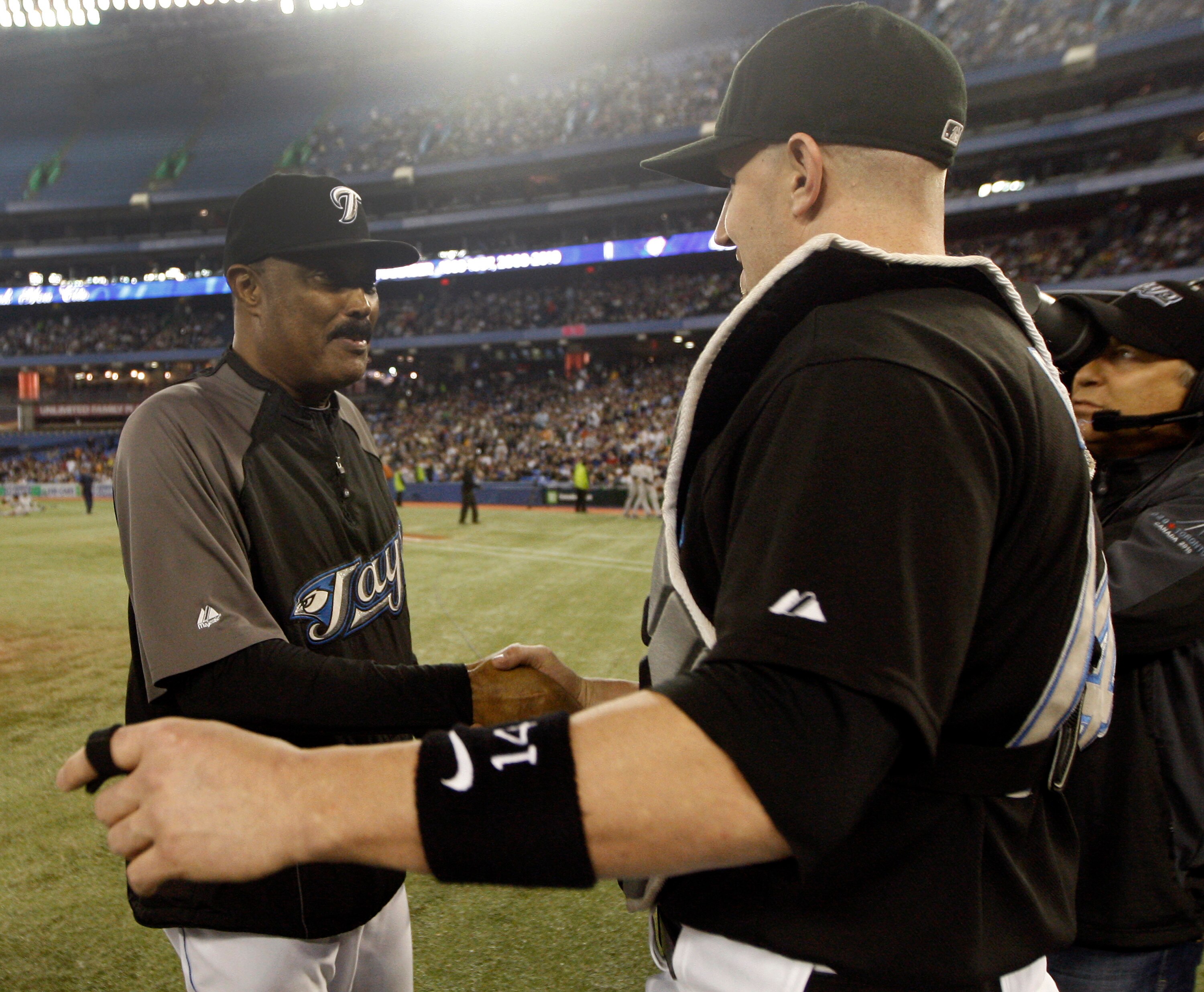 TORONTO, ON - SEPTEMBER 29:  Manager Cito Gaston takes his final walk and shakes hands with John Buck #14 on home field after the Toronto Blue Jays defeated the the New York Yankees 8-4 during a MLB game at the Rogers Centre September 29, 2010 in Toronto,