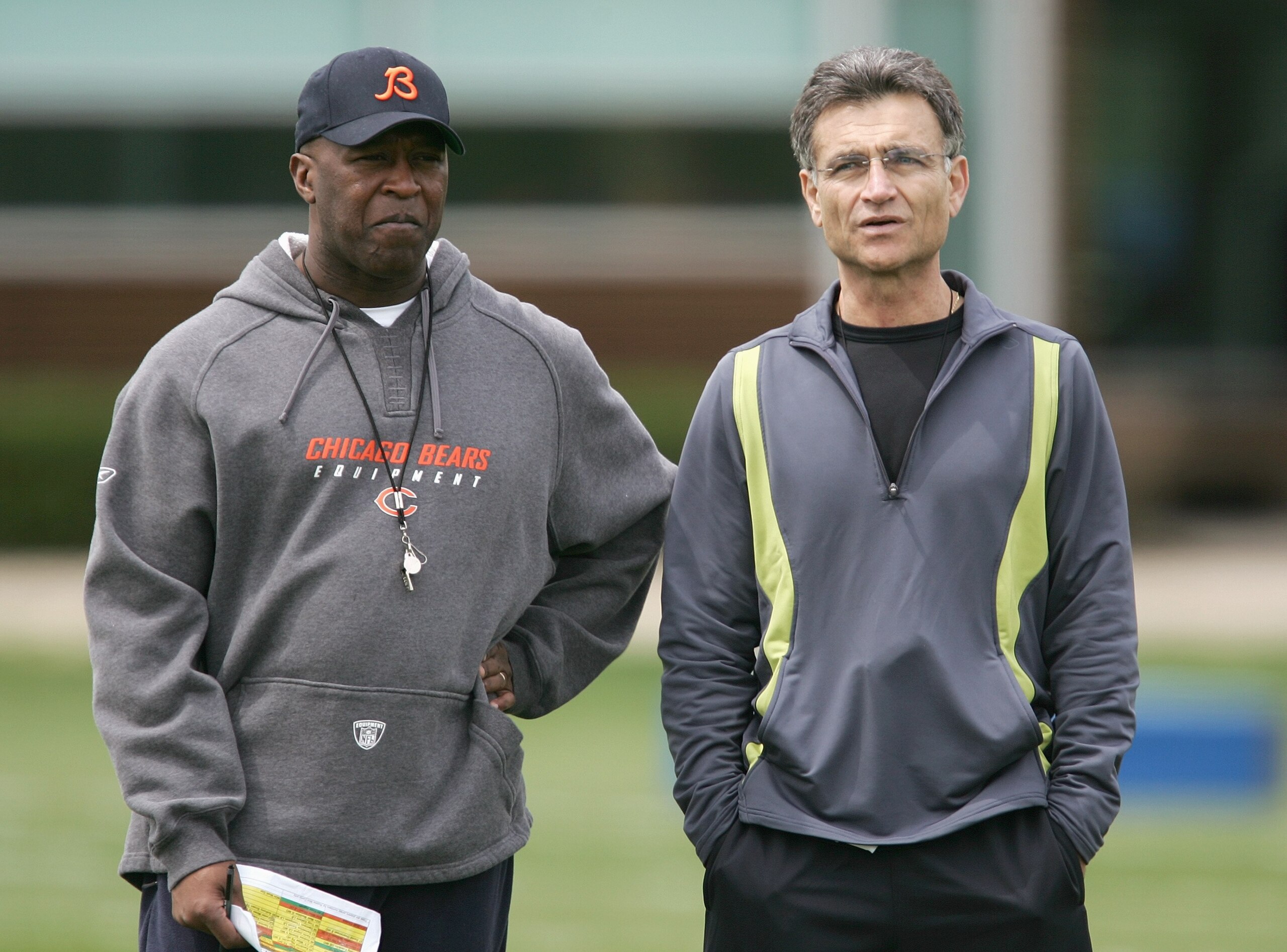 LAKE FOREST, IL - MAY 4: The head coach Lovie Smith (L) and general manager Jerry Angelo of the Chicago Bears look over players during a rookie mini-camp practice at Halas Hall May 4, 2007 in Lake Forest, Illinois. (Photo by Jonathan Daniel/Getty Images) LAKE FOREST, IL - MAY 4: The head coach Lovie Smith (L) and general manager Jerry Angelo of the Chicago Bears look over players during a rookie mini-camp practice at Halas Hall May 4, 2007 in Lake Forest, Illinois. (Photo by Jonathan Daniel/Getty Images)