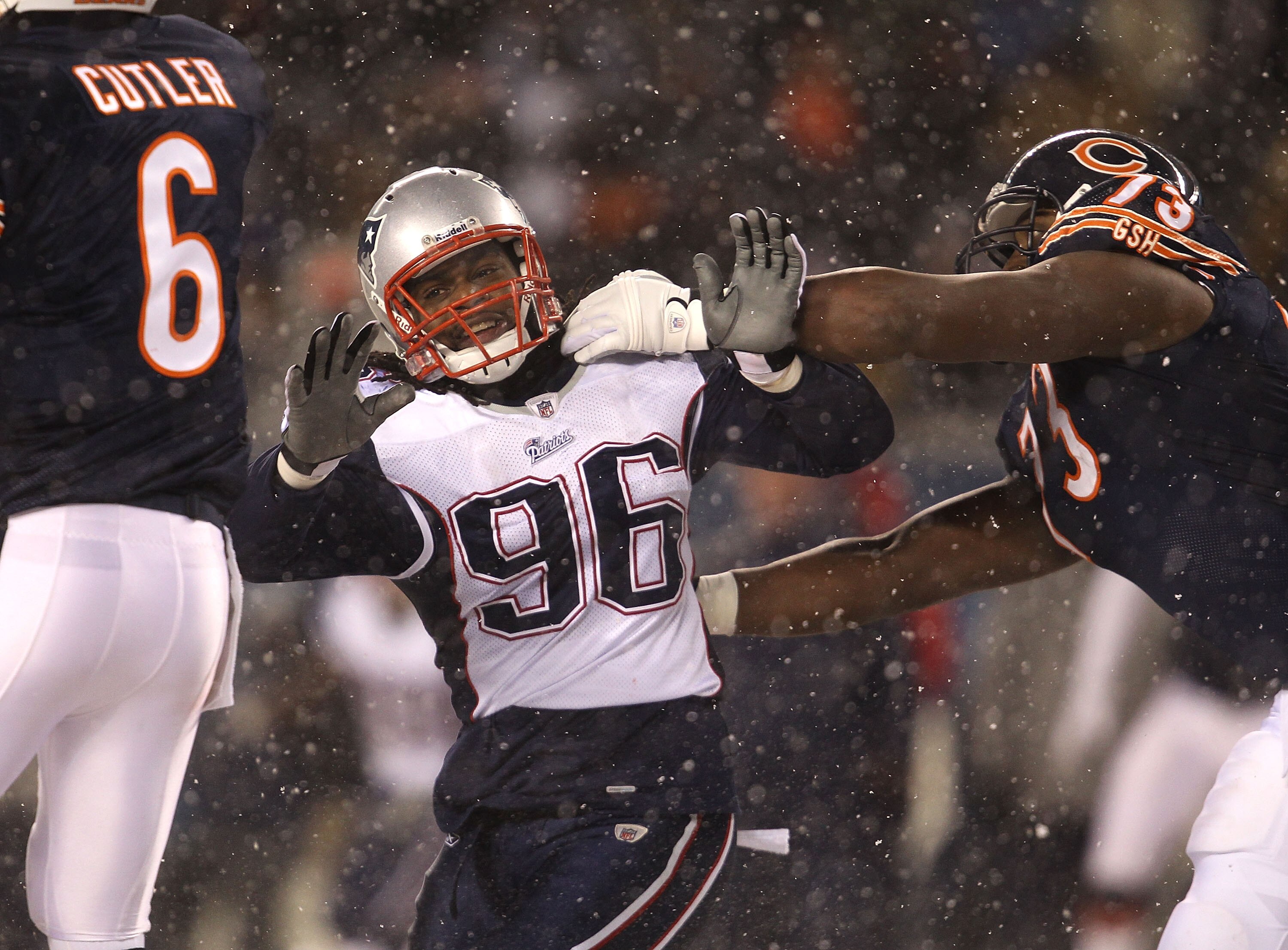 CHICAGO, IL - DECEMBER 12: Jermaine Cunningham #96 of the New England Patriots rushes past J'Marcus Webb #73 of the Chicago Bears towards Jay Cutler #6 at Soldier Field on December 12, 2010 in Chicago, Illinois. The Patriots defeated the Bears 36-7. (Phot