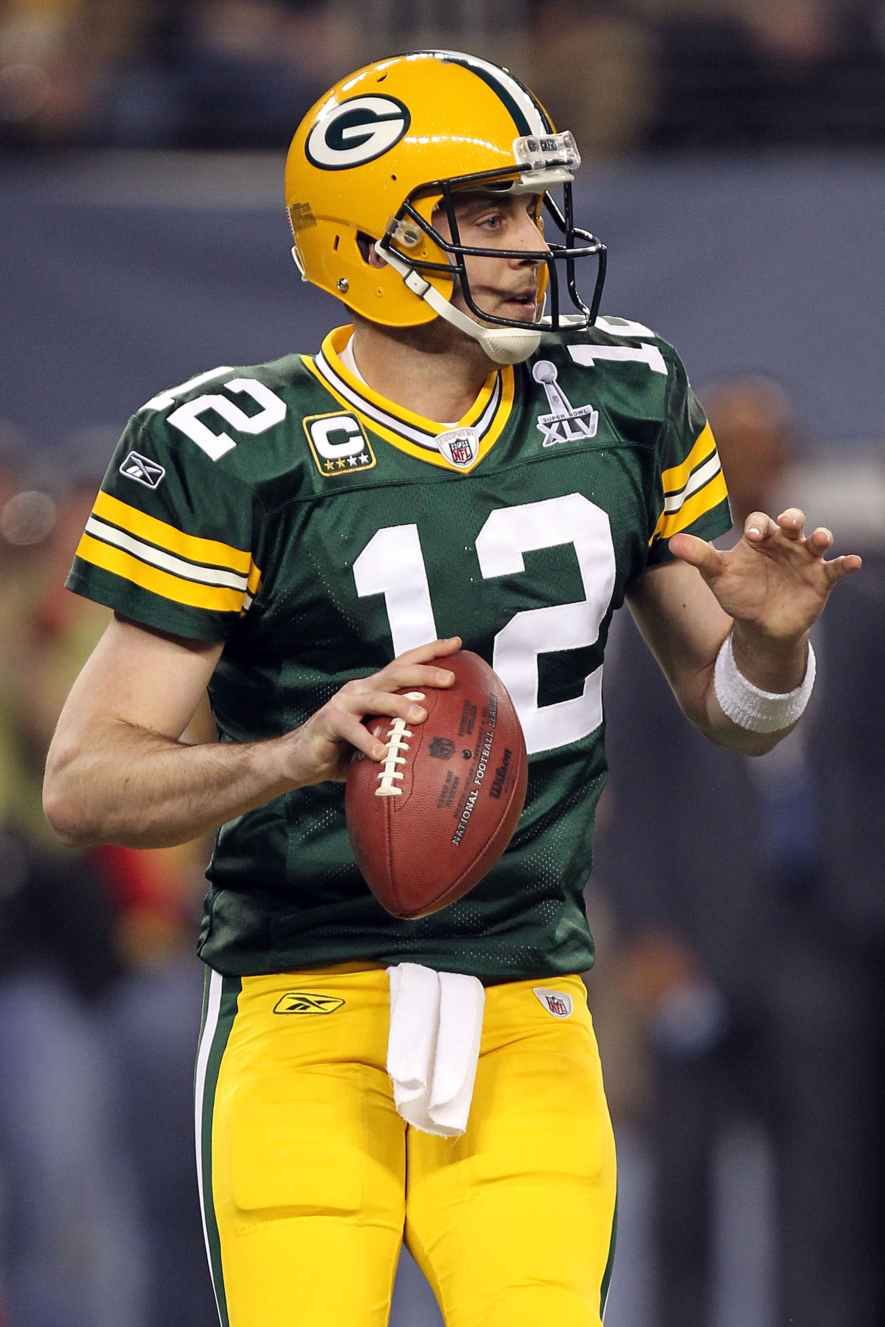 ARLINGTON, TX - FEBRUARY 06:  Aaron Rodgers #12 of the Green Bay Packers drops back against the Pittsburgh Steelers during the first quarter of Super Bowl XLV at Cowboys Stadium on February 6, 2011 in Arlington, Texas.  (Photo by Ronald Martinez/Getty Ima