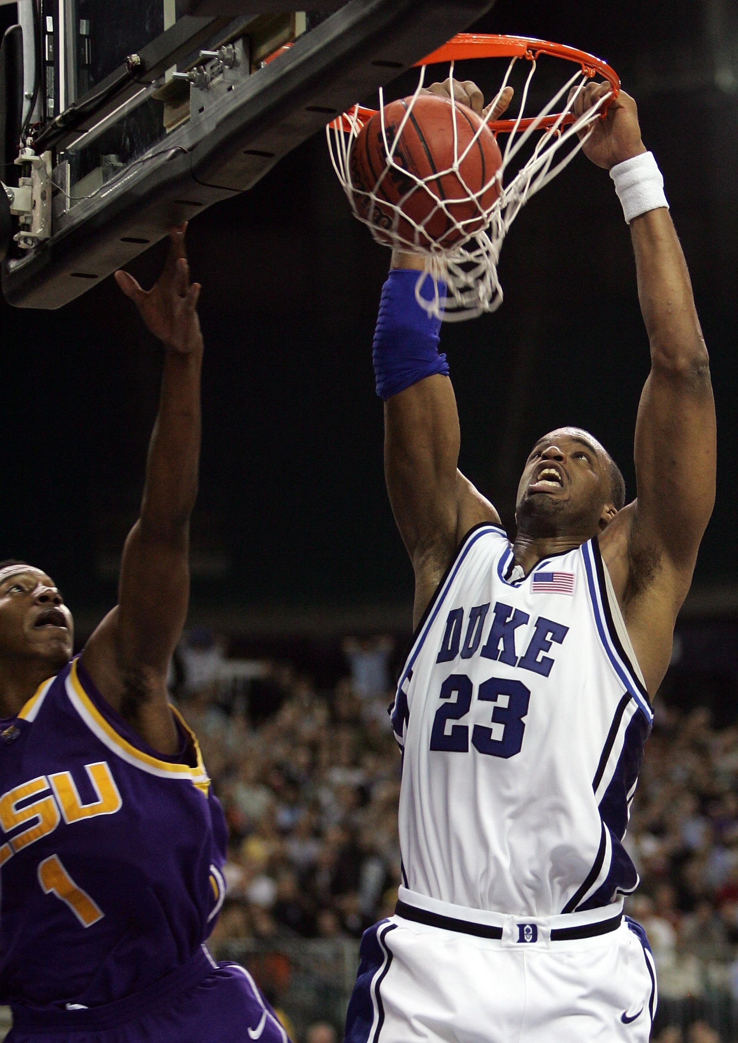 ATLANTA - MARCH 23: Shelden Williams #23 of the Duke Blue Devils dunks over the defense of Tasmin Mitchell #1 of the LSU Tigers during third round game of the 2006 NCAA Division I Men's Basketball Tournament Regional at the Georgia Dome on March 23, 2006