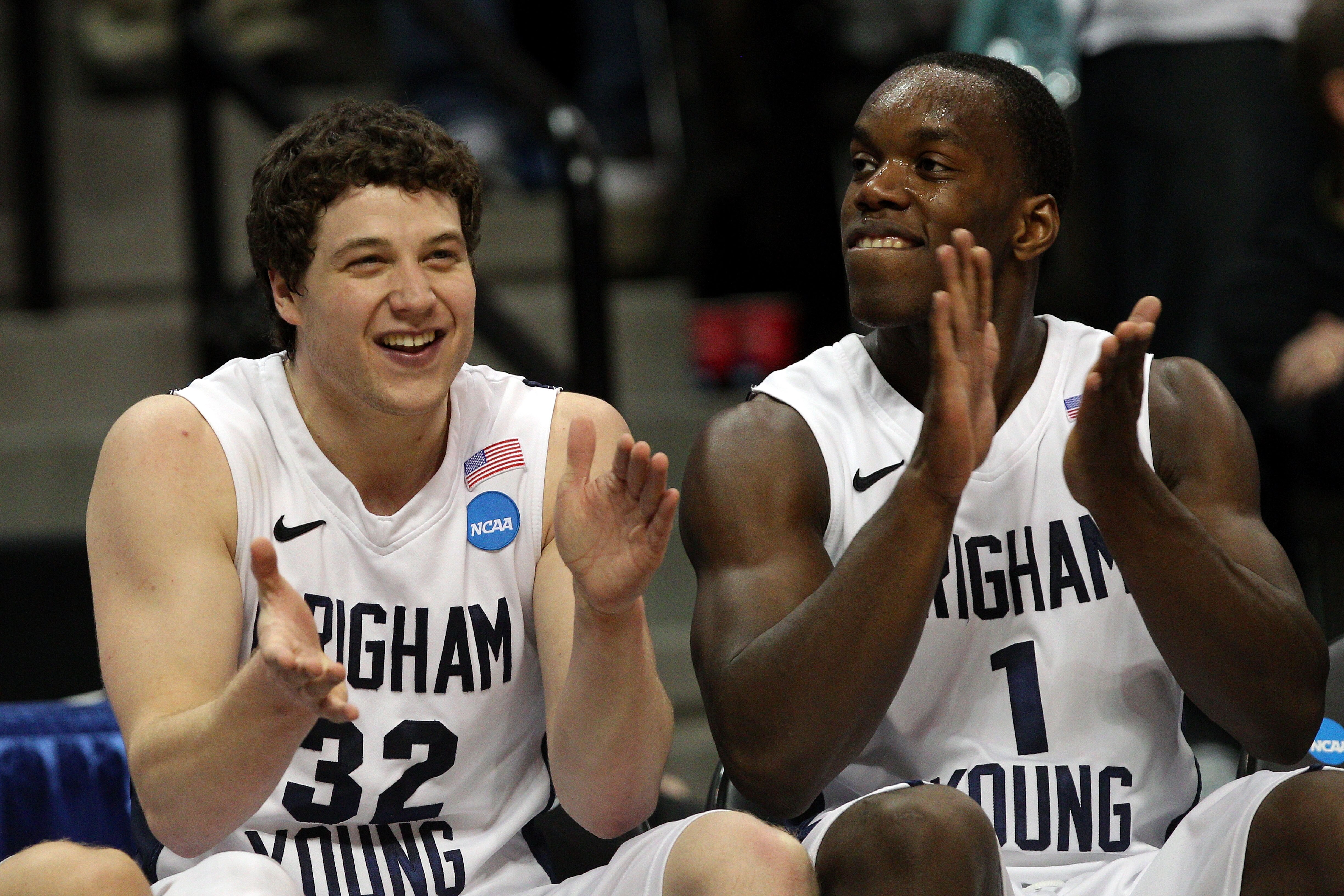 DENVER, CO - MARCH 19:  Jimmer Fredette #32 and Charles Abouo #1 of the Brigham Young Cougars celebrates on the bench towards the end of the game against the Gonzaga Bulldogs during the third round of the 2011 NCAA men's basketball tournament at Pepsi Cen