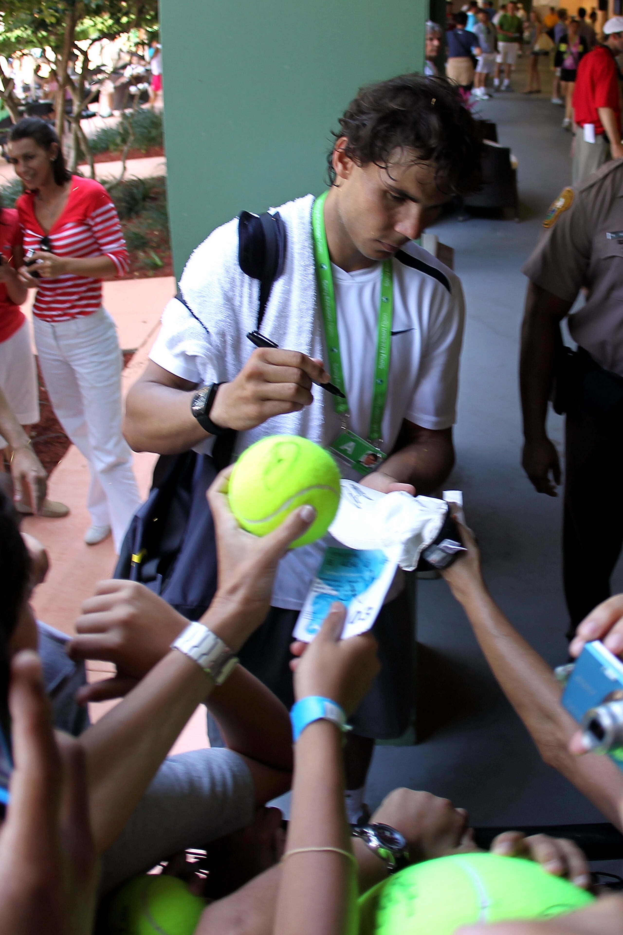 KEY BISCAYNE, FL - MARCH 23:  Rafael Nadal of Spain signs autographs for fans during the Sony Ericsson Open at Crandon Park Tennis Center on March 23, 2011 in Key Biscayne, Florida.  (Photo by Mike Ehrmann/Getty Images)