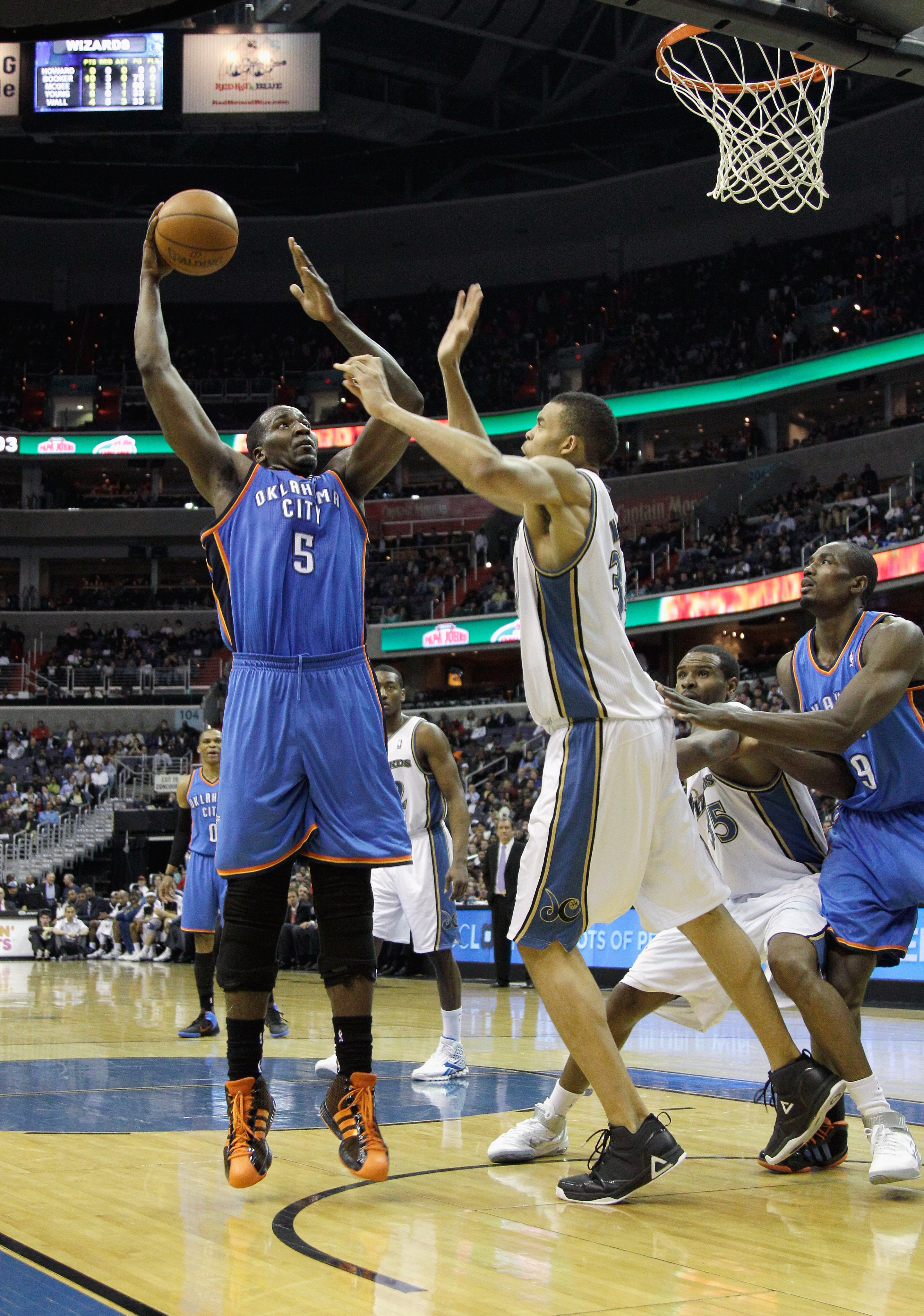 WASHINGTON, DC - MARCH 14: Kendrick Perkins #5 of the Oklahoma City Thunder puts up a shot in front of JaVale McGee #34 of the Washington Wizards during the first half at the Verizon Center on March 14, 2011 in Washington, DC. NOTE TO USER: User expressly