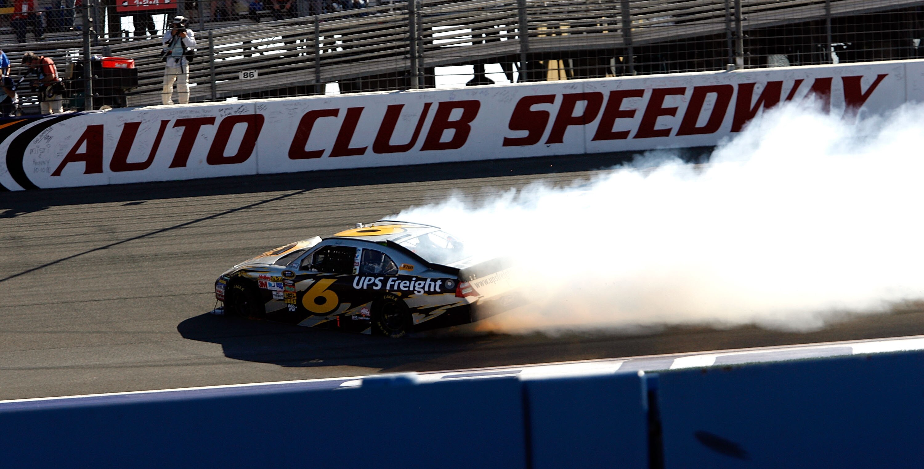 FONTANA, CA - OCTOBER 10:  David Ragan, driver of the #6 UPS Ford, and Kurt Busch, driver of the #2 Miller Lite Dodge, crash in to each other during the NASCAR Sprint Cup Series Pepsi Max 400 on October 10, 2010 in Fontana, California.  (Photo by Tom Penn