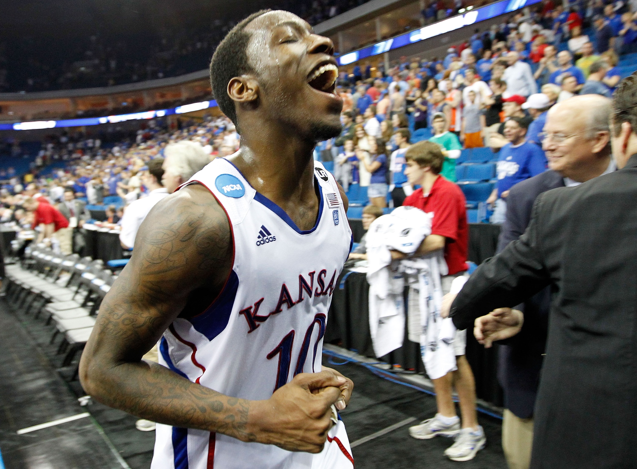 TULSA, OK - MARCH 20: Tyshawn Taylor #10 of the Kansas Jayhawks jogs off the court after defeating the Illinois Fighting Illini 59-73 in the third round of the 2011 NCAA men's basketball tournament at BOK Center on March 20, 2011 in Tulsa, Oklahoma. (Ph TULSA, OK - MARCH 20: Tyshawn Taylor #10 of the Kansas Jayhawks jogs off the court after defeating the Illinois Fighting Illini 59-73 in the third round of the 2011 NCAA men's basketball tournament at BOK Center on March 20, 2011 in Tulsa, Oklahoma. (Ph