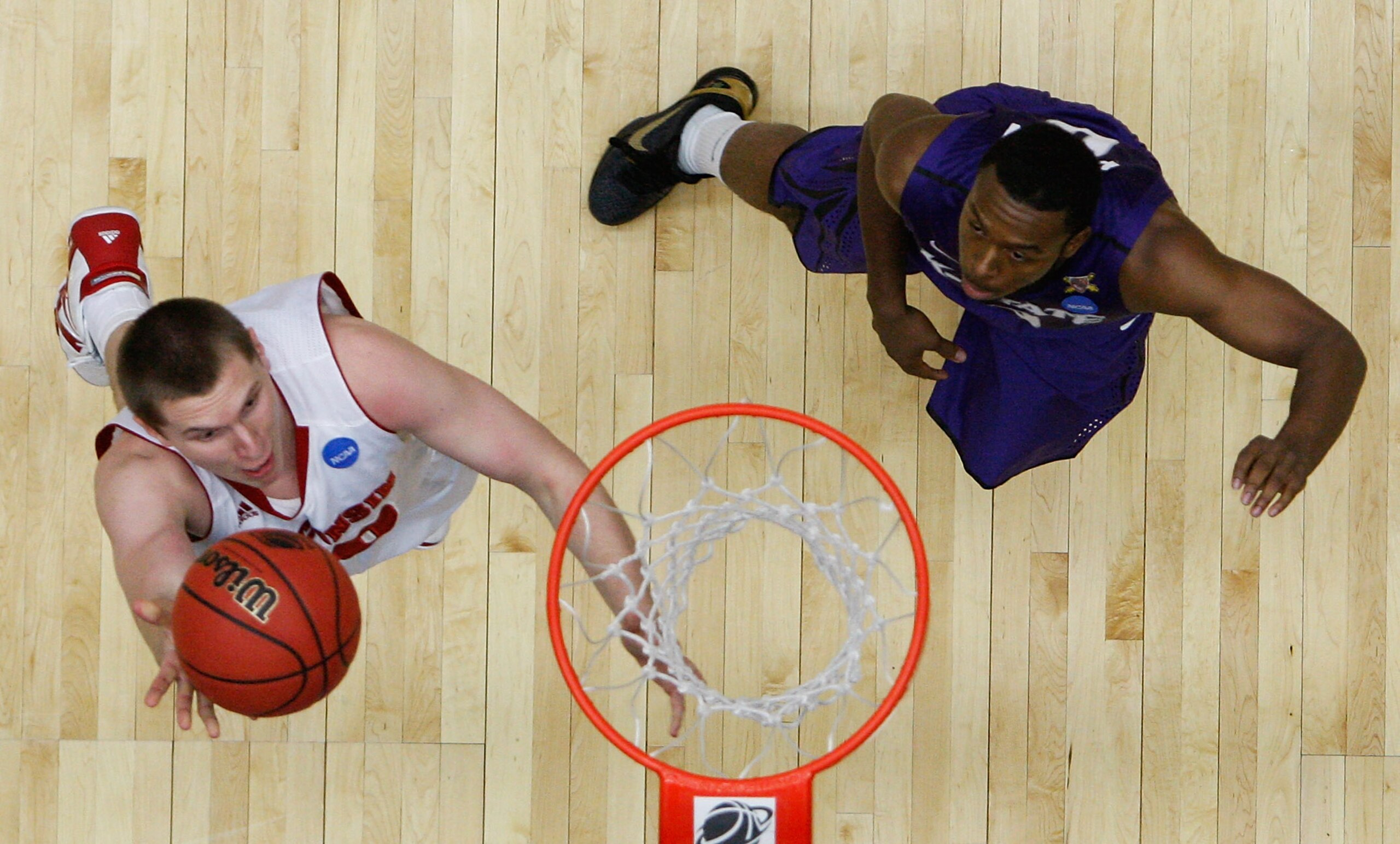 TUCSON, AZ - MARCH 19:  Jon Leuer #30 of the Wisconsin Badgers shoots against Jacob Pullen #0 of the Kansas State Wildcats during the third round of the 2011 NCAA men's basketball tournament at McKale Center on March 19, 2011 in Tucson, Arizona.  (Photo b
