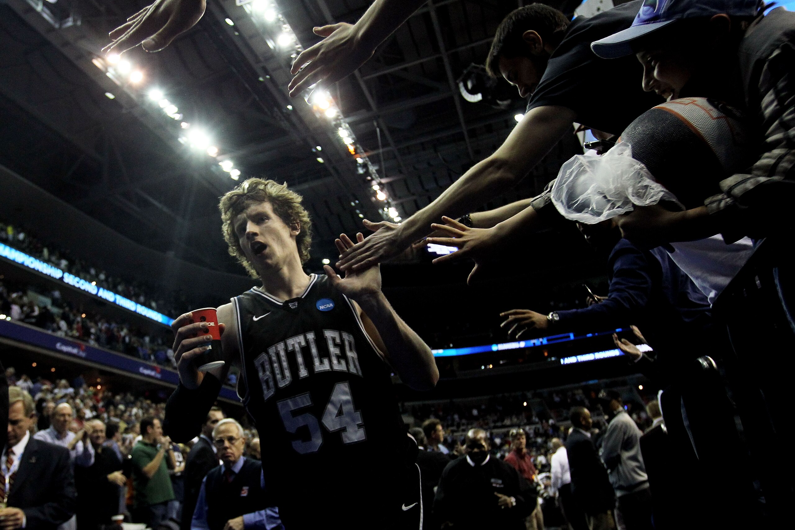 WASHINGTON - MARCH 19:  Matt Howard #54 of the Butler Bulldogs celebrates with fans after their victory over the Pittsburgh Panthers during the third round of the 2011 NCAA men's basketball tournament at Verizon Center on March 19, 2011 in Washington, DC.