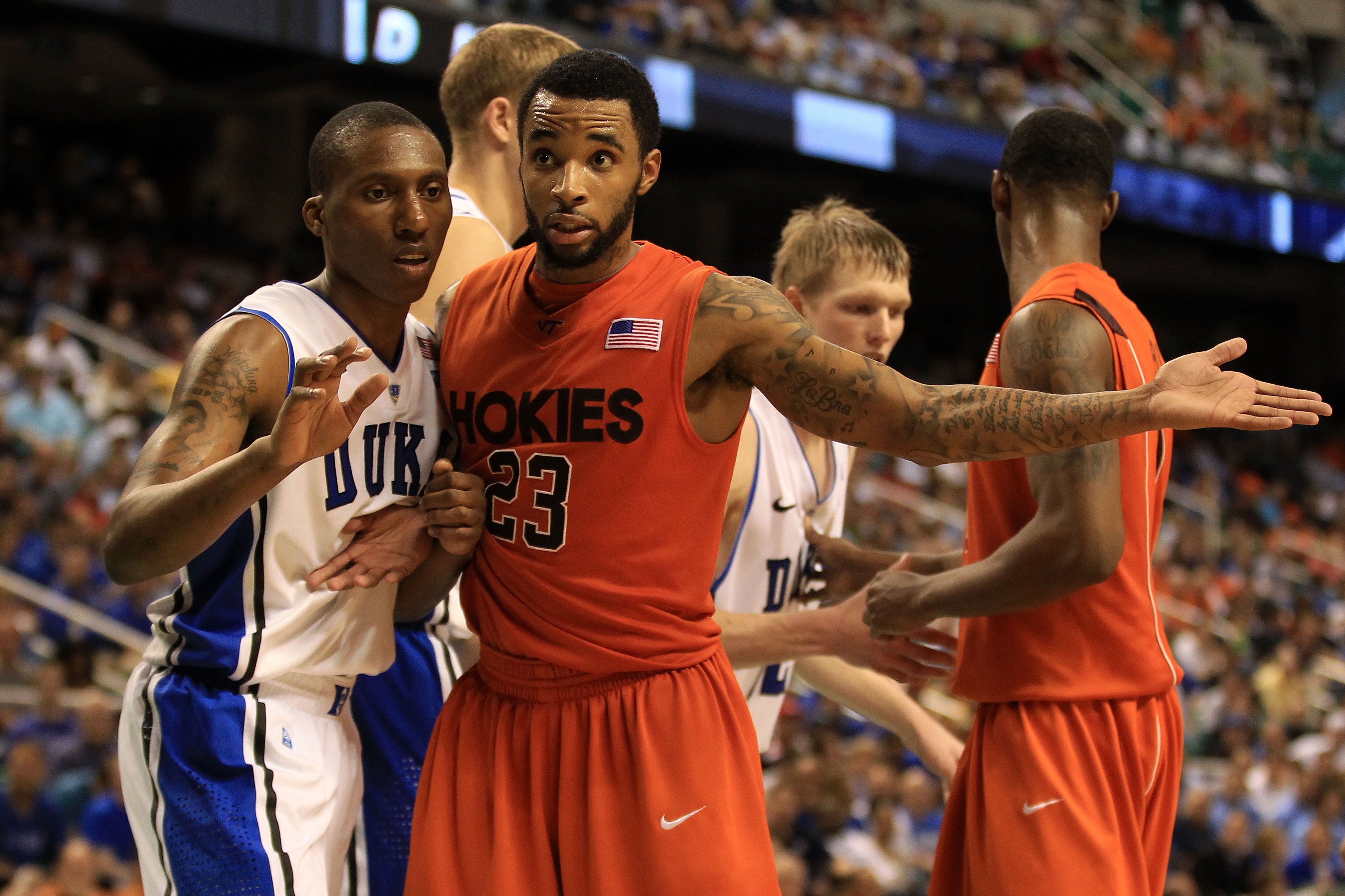 GREENSBORO, NC - MARCH 12:  Malcolm Delaney #23 of the Virginia Tech Hokies reacts alongside Nolan Smith #2 of the Duke Blue Devils during the second half in the semifinals of the 2011 ACC men's basketball tournament at the Greensboro Coliseum on March 12