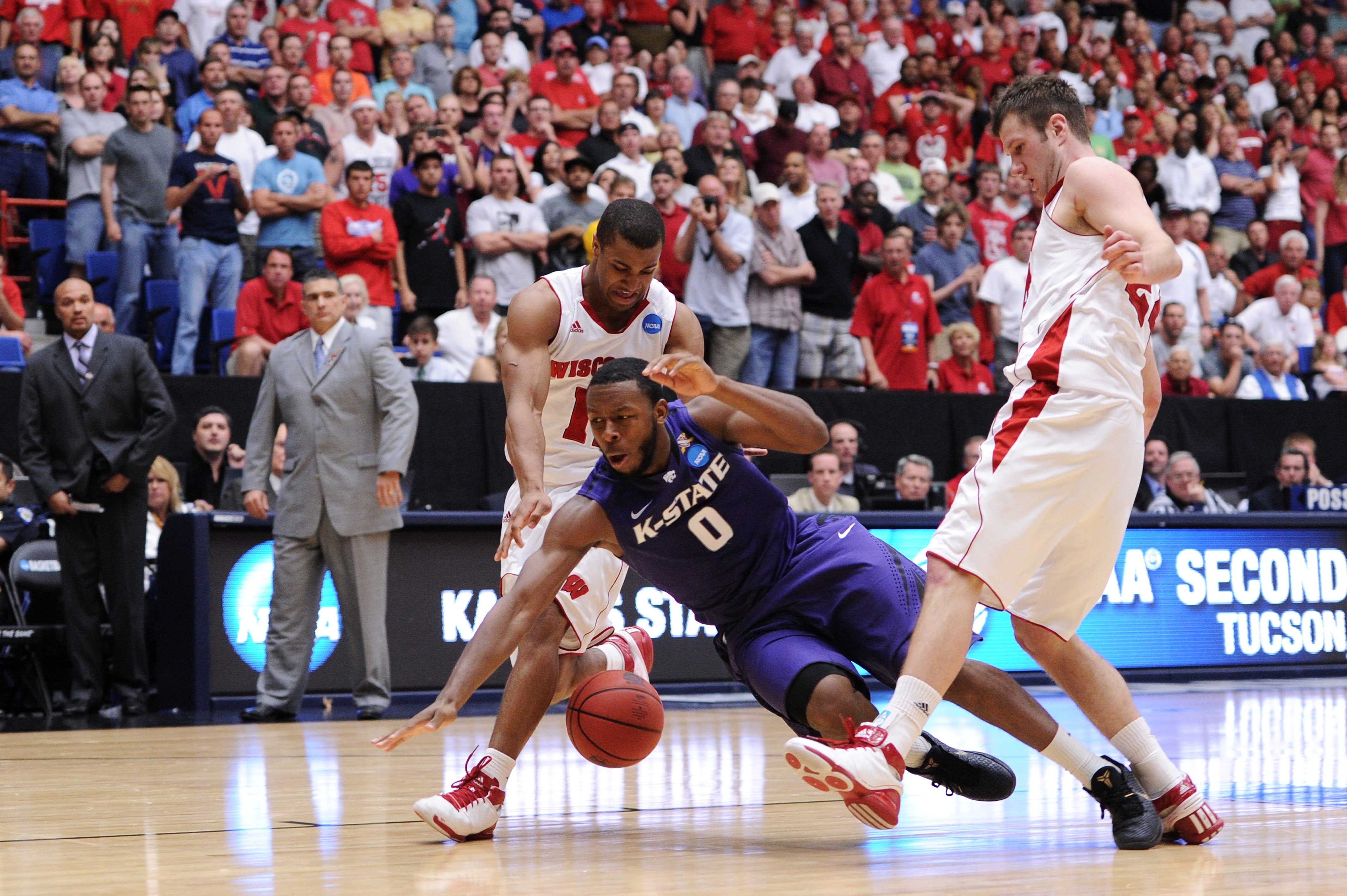 TUCSON, AZ - MARCH 19:  Jacob Pullen #0 of the Kansas State Wildcats looses control of the ball inbetween Jordan Taylor #11 and Tim Jarmusz #24 of the Wisconsin Badgers during the third round of the 2011 NCAA men's basketball tournament at McKale Center o