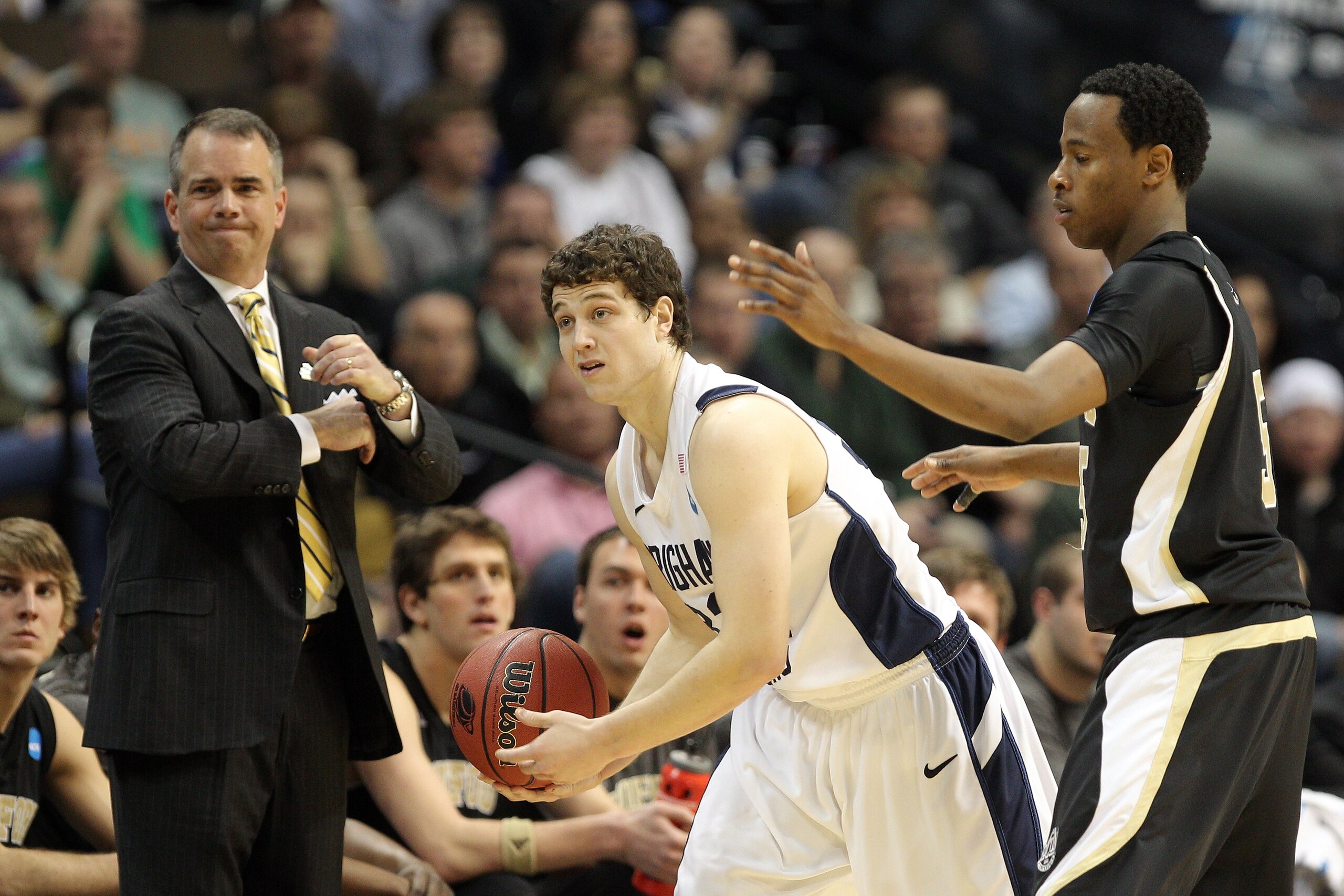 DENVER, CO - MARCH 17:  Jamar Diggs #5 of the Wofford Terriers defends against Jimmer Fredette #32 of the Brigham Young Cougars as he and head coach Dave Rose reacts to a call during the second round of the 2011 NCAA men's basketball tournament at Pepsi C