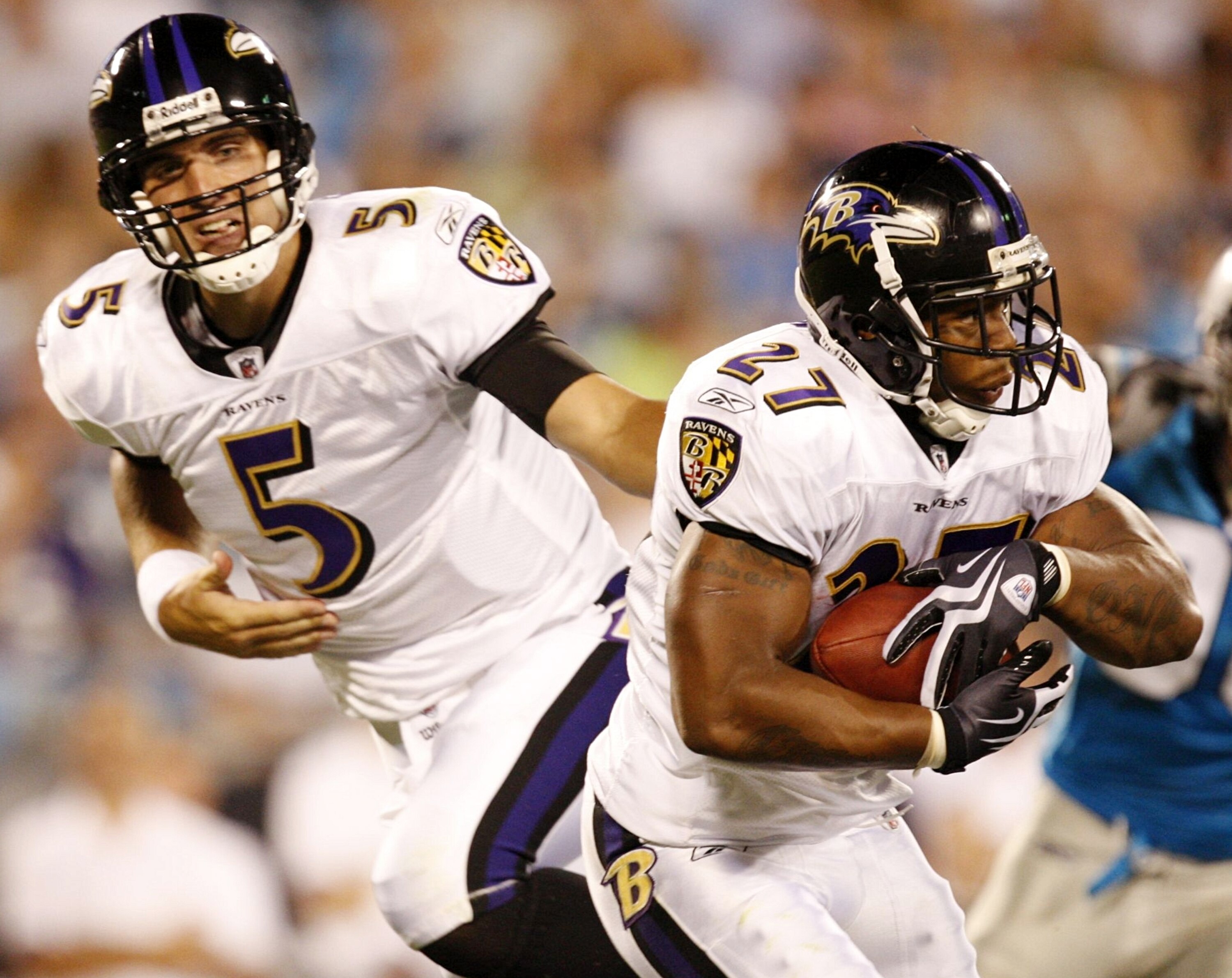 CHARLOTTE, NC - AUGUST 29: Running back Ray Rice #27 of the Baltimore Ravens get a hand off from quarterback Joe Flacco #5 during their game against the Carolina Panthers at Bank of America Stadium on August 29, 2009 in Charlotte, North Carolina. (Photo b