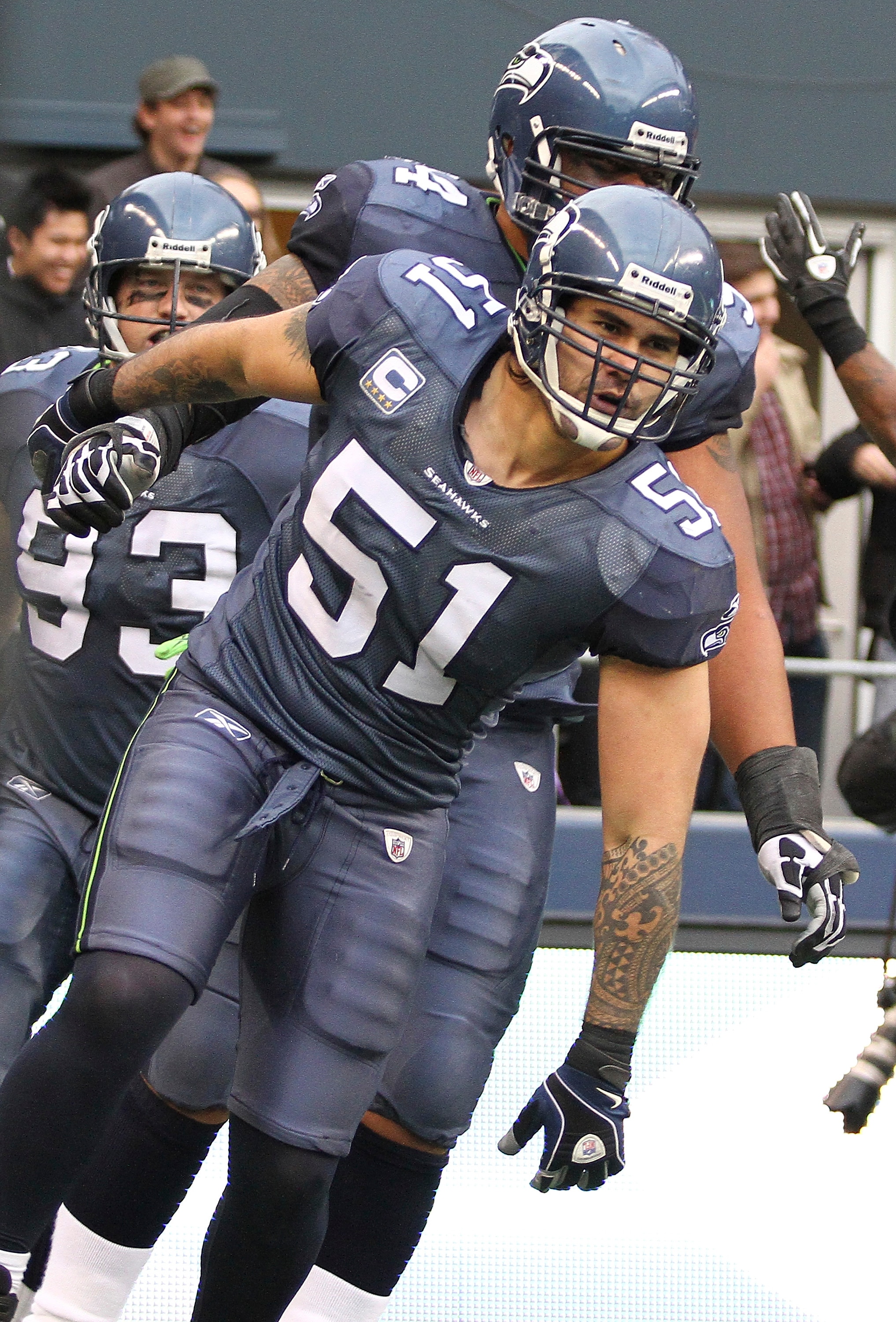 SEATTLE, WA - DECEMBER 05:  Linebacker Lofa Tatupu #51 of the Seattle Seahawks celebrates with teammates after returning an interception for a touchdown against the Carolina Panthers at Qwest Field on December 5, 2010 in Seattle, Washington. The Seahawks
