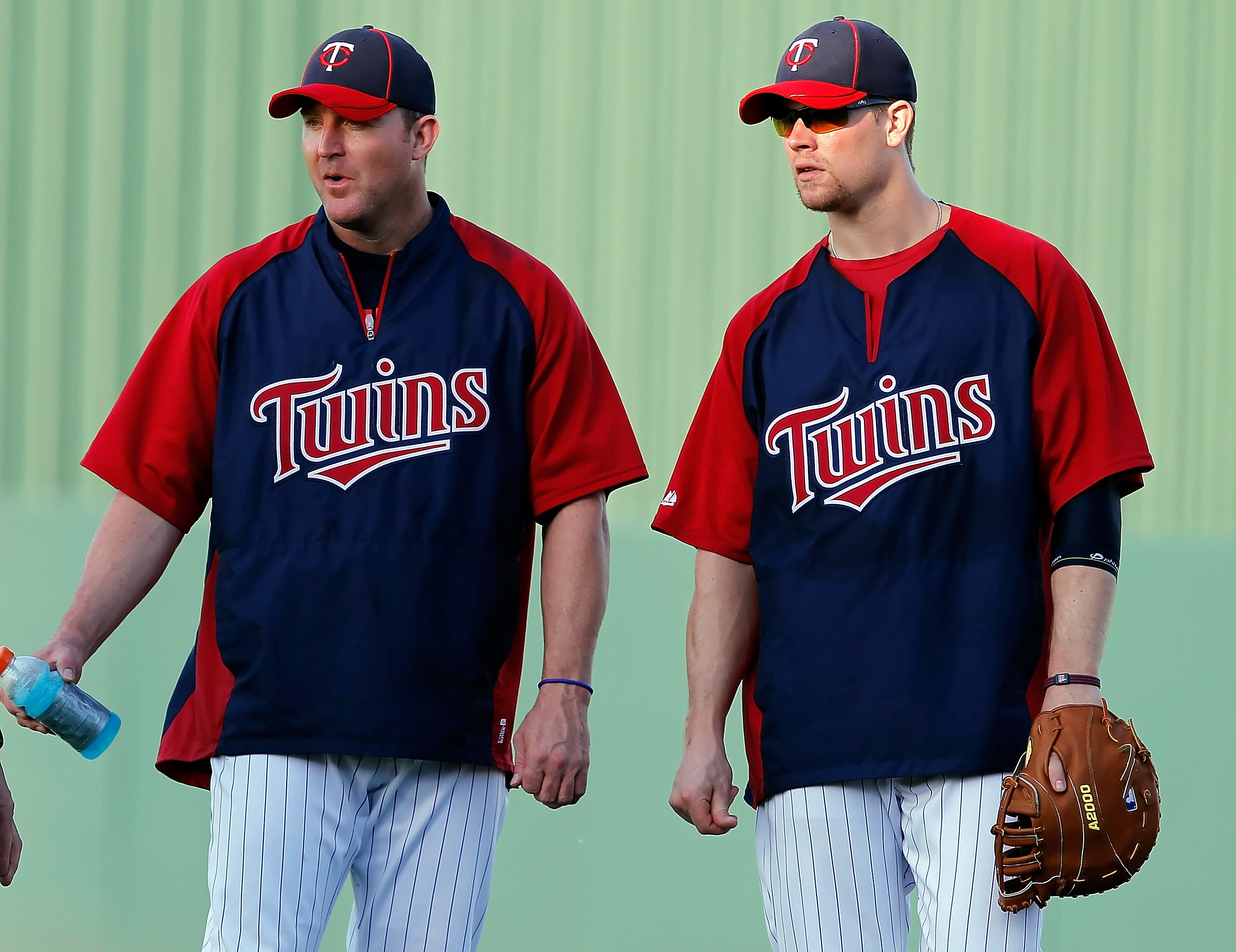 FORT MYERS, FL - FEBRUARY 27:  (L - R) Infielder Jim Thome #25 and first baseman Justin Morneau #33 of the Minnesota Twins talk just before the start of the Grapefruit League Spring Training Game against the Boston Red Sox at Hammond Stadium on February 2