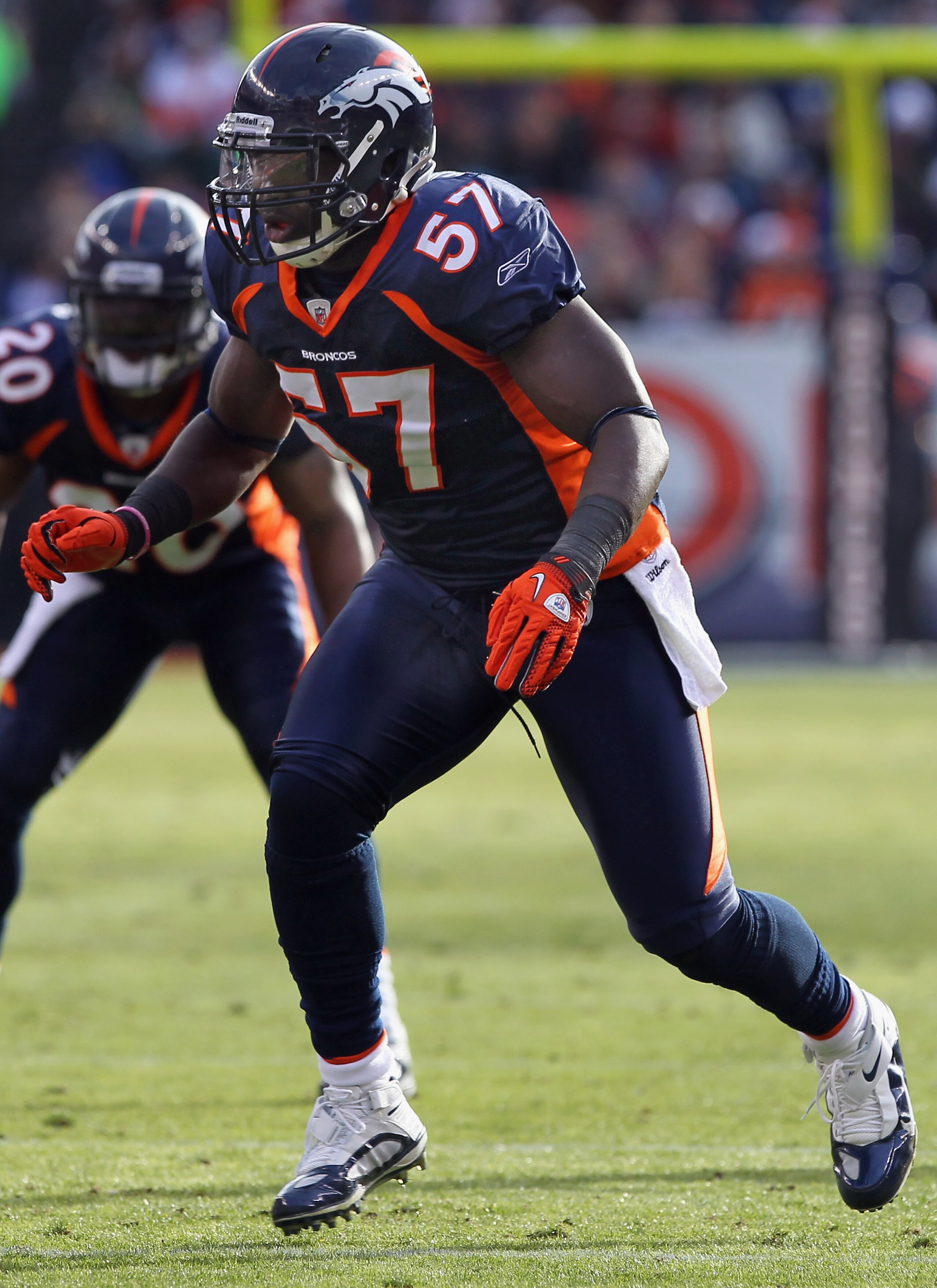 DENVER - DECEMBER 26:  Linebacker Mario Haggen #57 of the Denver Broncos defends against the Houston Texans at INVESCO Field at Mile High on December 26, 2010 in Denver, Colorado. The Broncos defeated the Texans 24-23.  (Photo by Doug Pensinger/Getty Imag