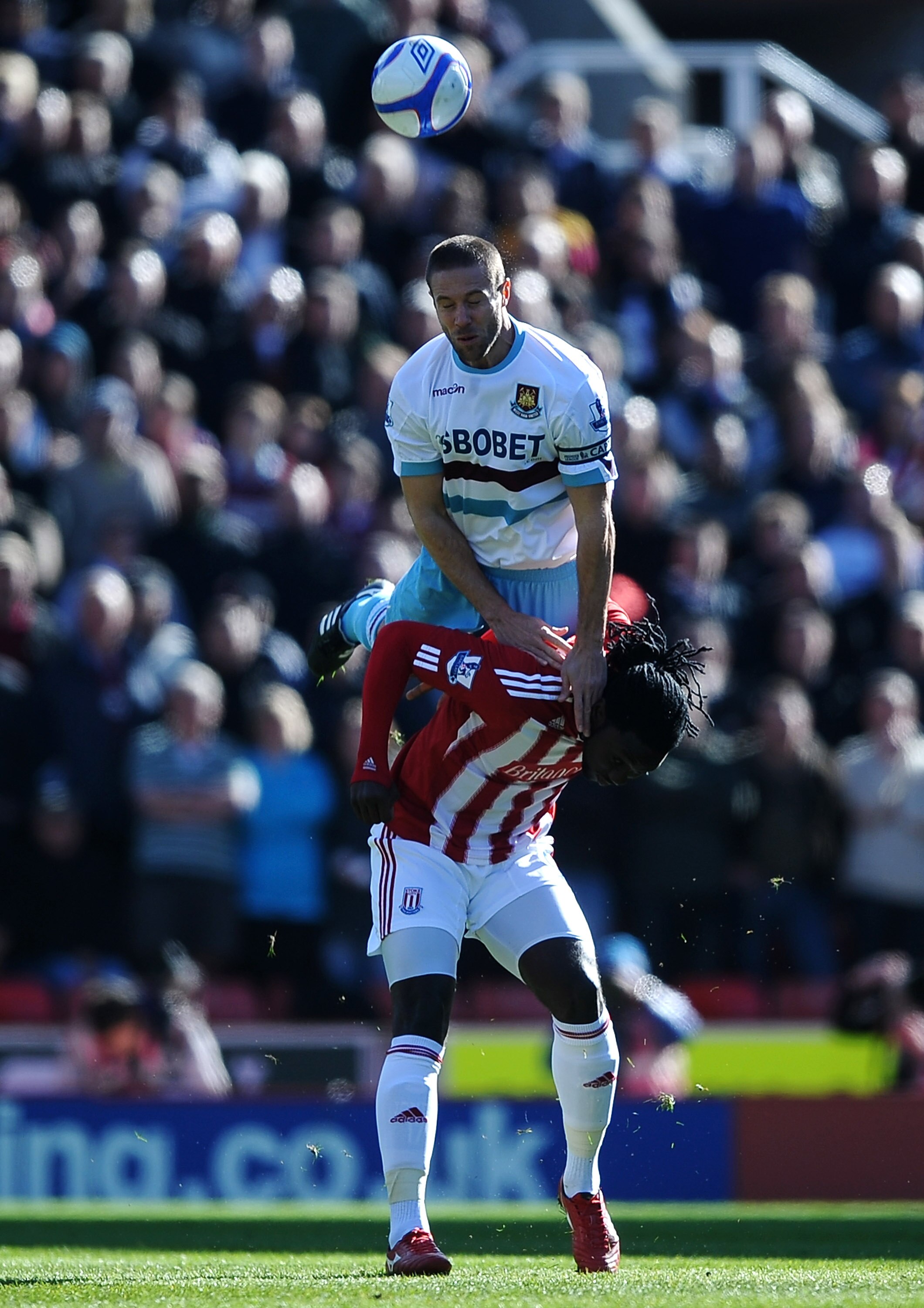 STOKE ON TRENT, ENGLAND - MARCH 13: Matthew Upson of West Ham United climbs above Kenwyne Jones of Stoke City during the FA Cup sponsored by E.ON 6th Round match between Stoke City and West Ham United at the Britannia Stadium on March 13, 2011 in Stoke on