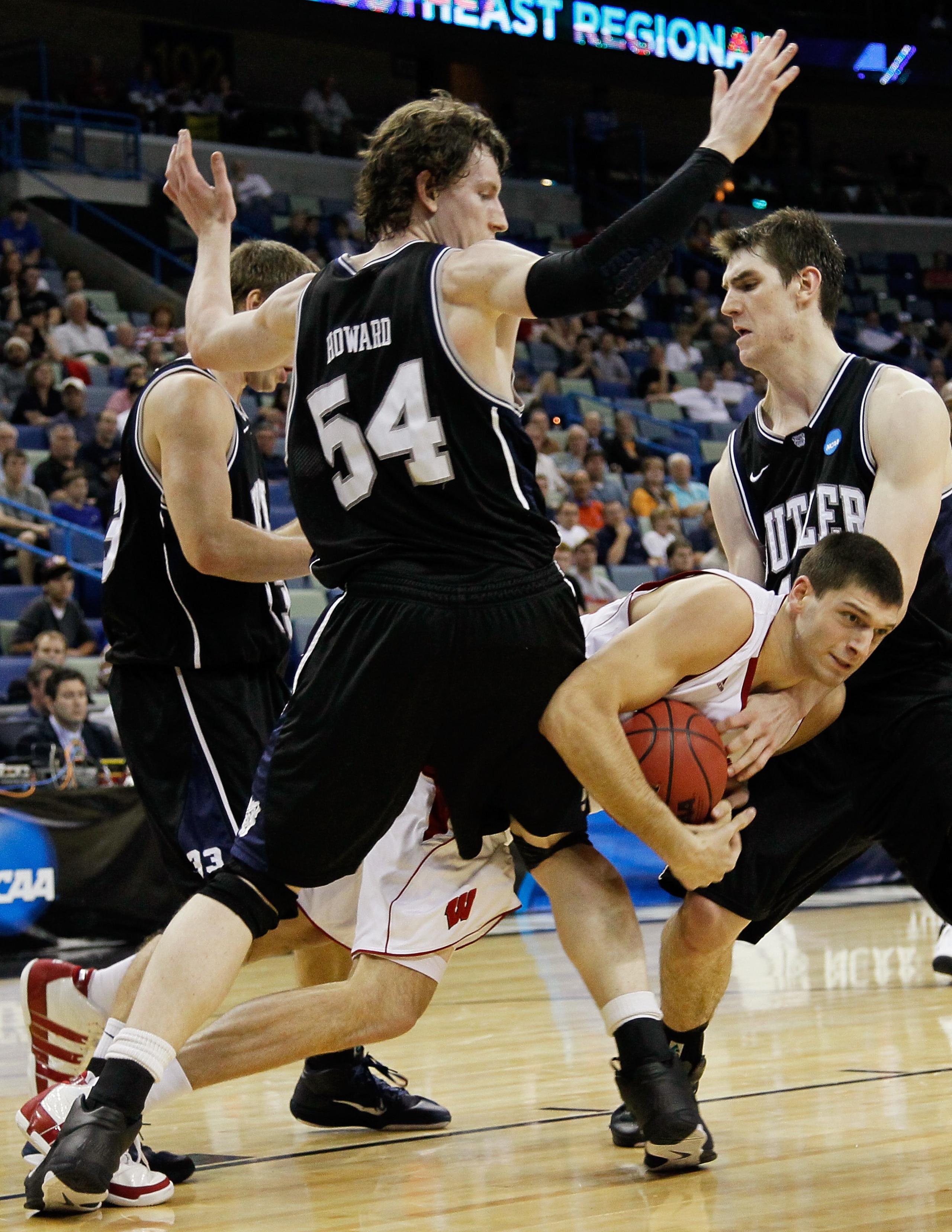 NEW ORLEANS, LA - MARCH 24: Keaton Nankivil #52 of the Wisconsin Badgers is tripped up between Matt Howard #54 and J.P. Gavinski #44 of the Wisconsin Badgers during the Southeast regional of the 2011 NCAA men's basketball tournament at New Orleans Arena NEW ORLEANS, LA - MARCH 24: Keaton Nankivil #52 of the Wisconsin Badgers is tripped up between Matt Howard #54 and J.P. Gavinski #44 of the Wisconsin Badgers during the Southeast regional of the 2011 NCAA men's basketball tournament at New Orleans Arena
