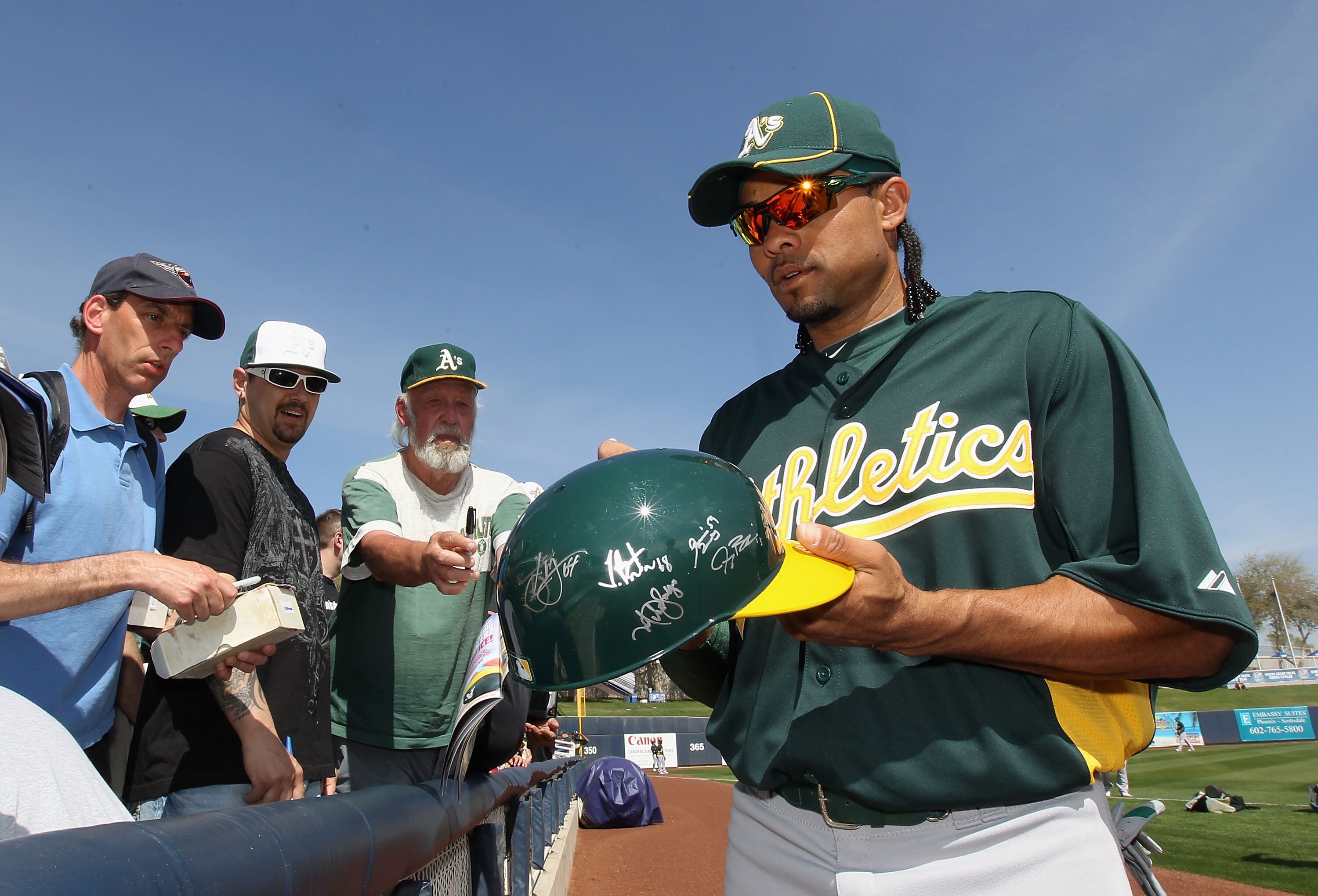 PHOENIX, AZ - MARCH 03:  Outfielder Coco Crisp #4 of the Oakland Athletics signs autographs for fans before the spring training game against the Milwaukee Brewers at Maryvale Baseball Park on March 3, 2011 in Phoenix, Arizona.  (Photo by Christian Peterse
