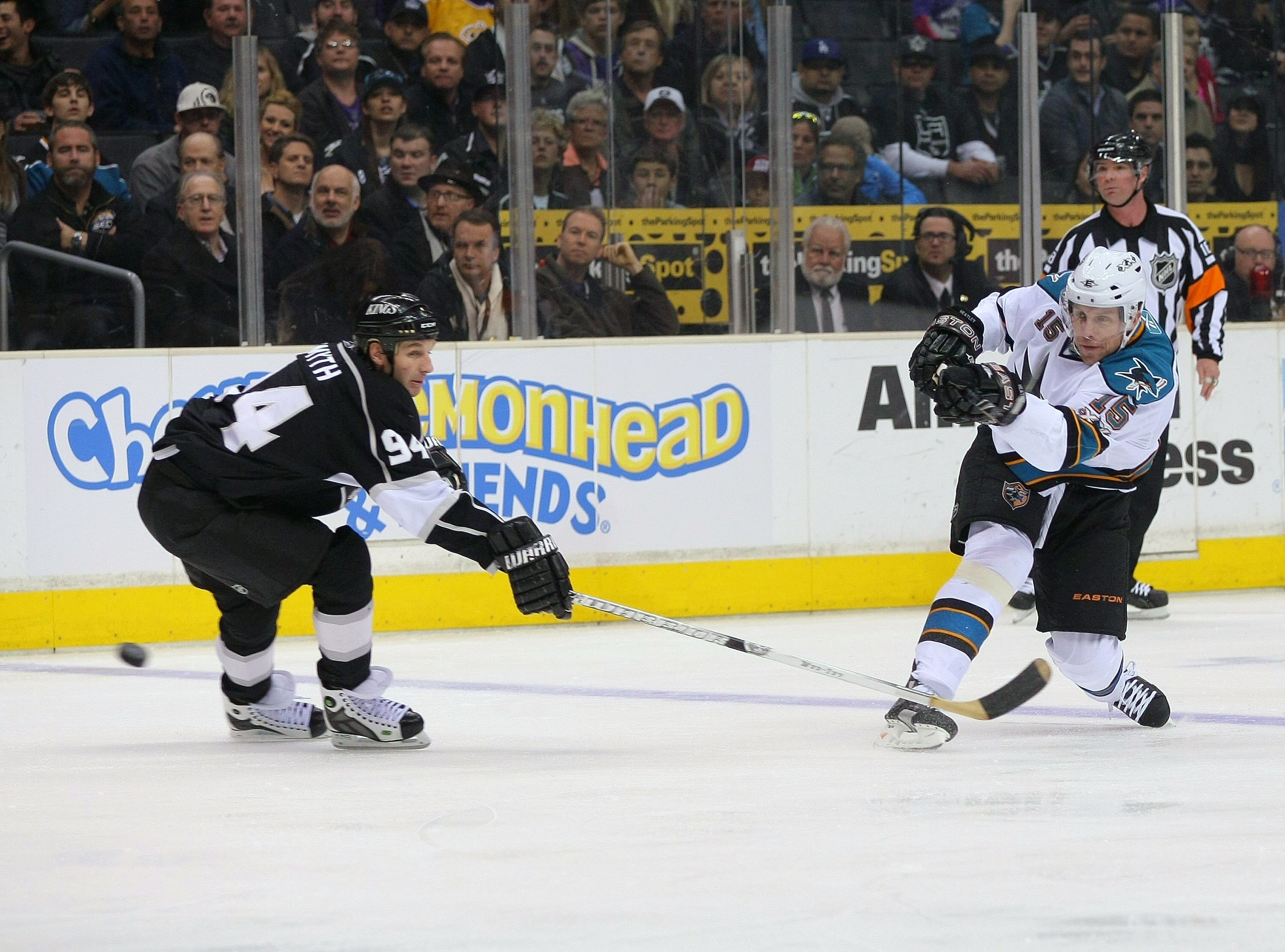 LOS ANGELES, CA - MARCH 24:  Dany Heatley #15 of the San Jose Sharks shoots the puck into the offensive zone  against Ryan Smyth #94 of the Los Angeles Kings in the first period during the NHL game at Staples Center on March 24, 2011 in Los Angeles, Calif