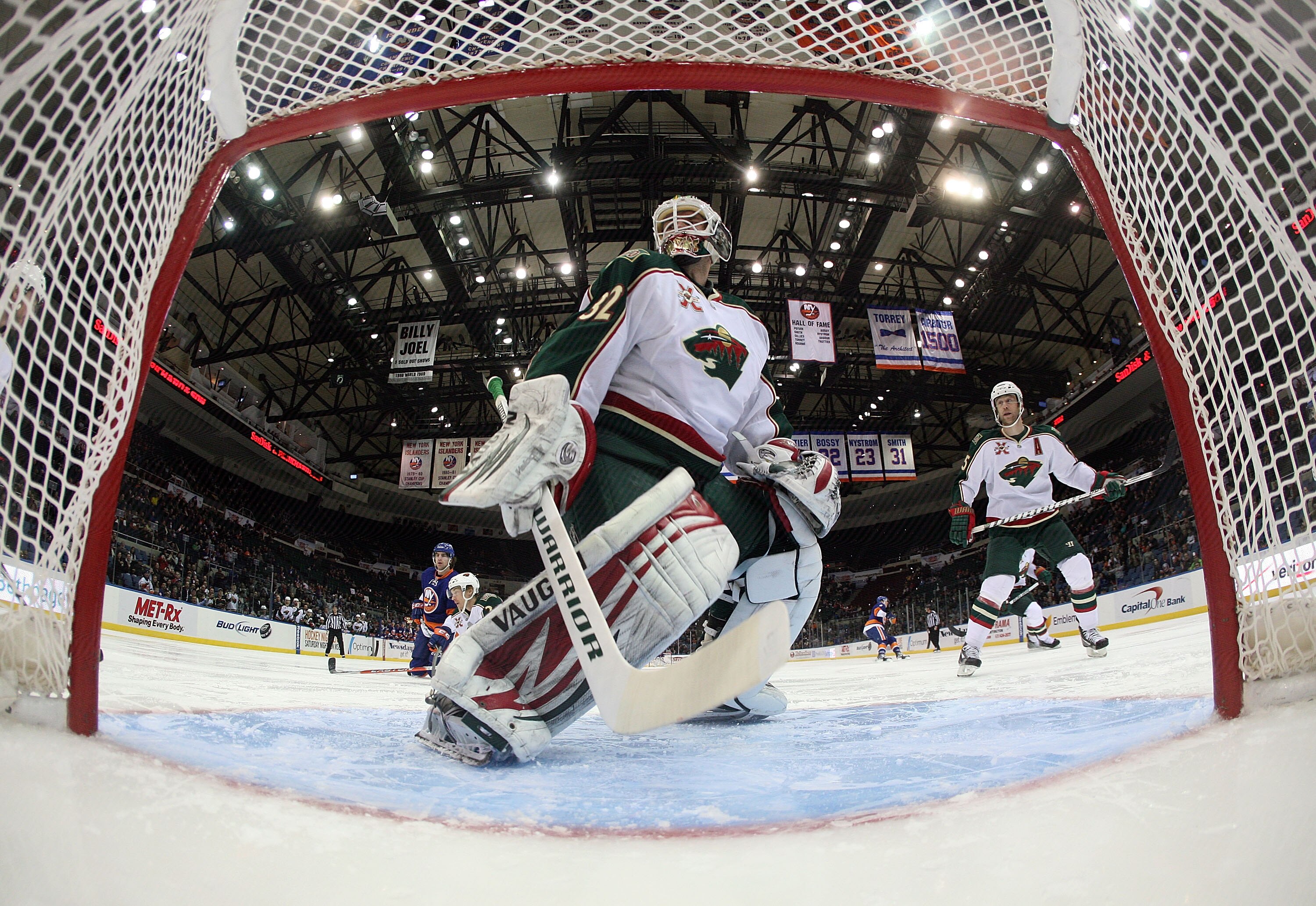 UNIONDALE, NY - MARCH 02:  Niklas Backstrom #32 of the Minnesota Wild defends the net against the New York Islanders at the Nassau Coliseum on March 2, 2011 in Uniondale, New York. The Islanders defeated the Wild 4-1.  (Photo by Bruce Bennett/Getty Images